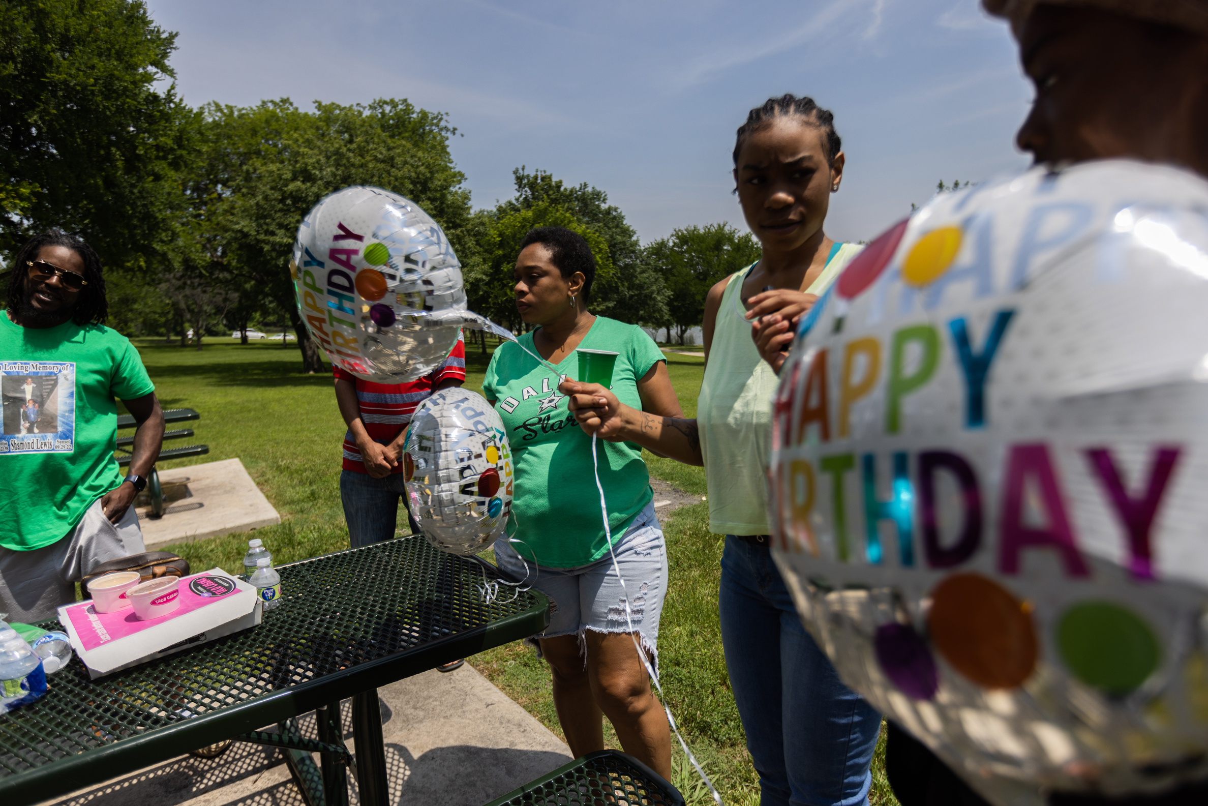 Family holds balloons in the park