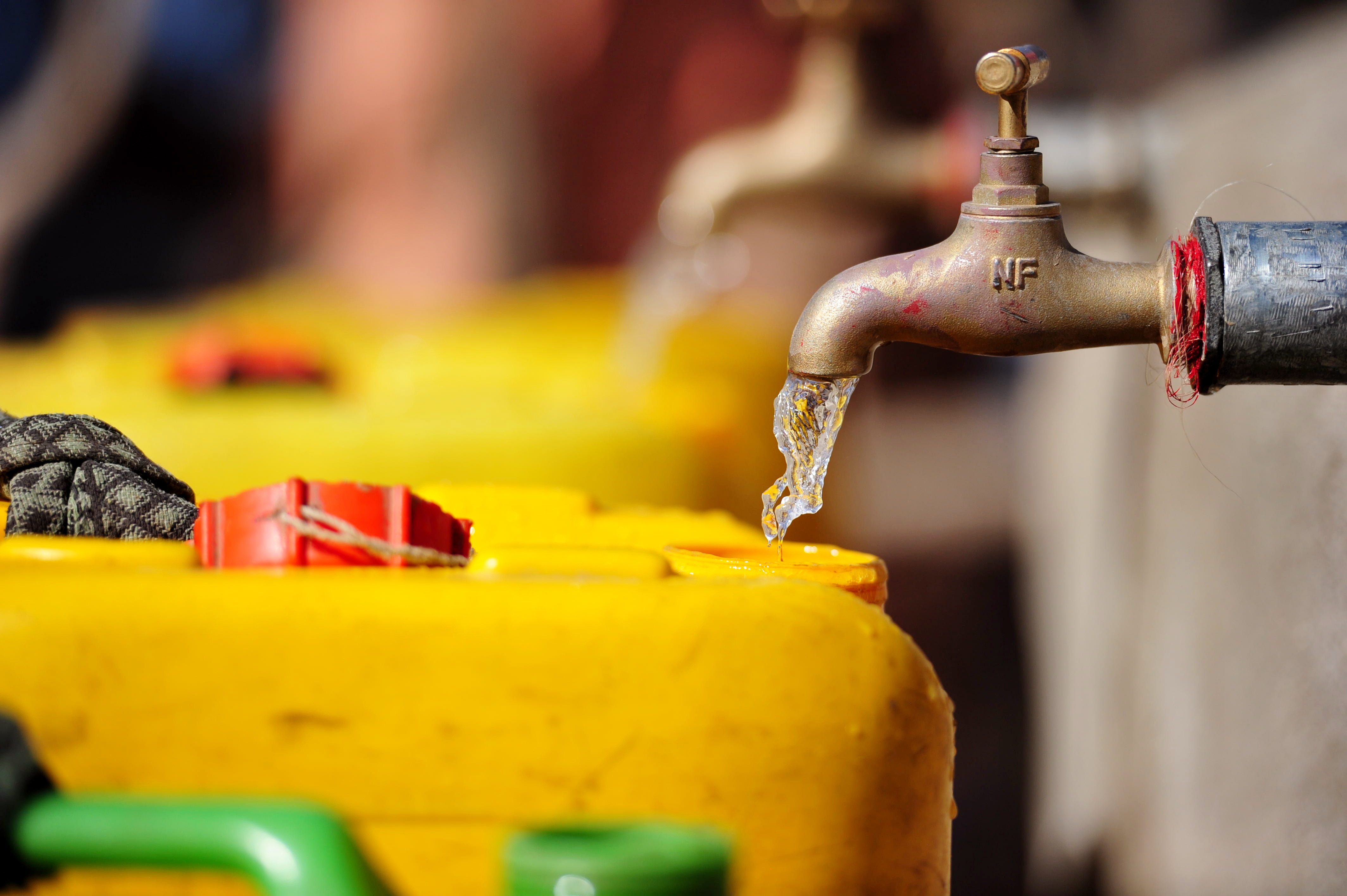 Water going into a jerry can at a charity: water project