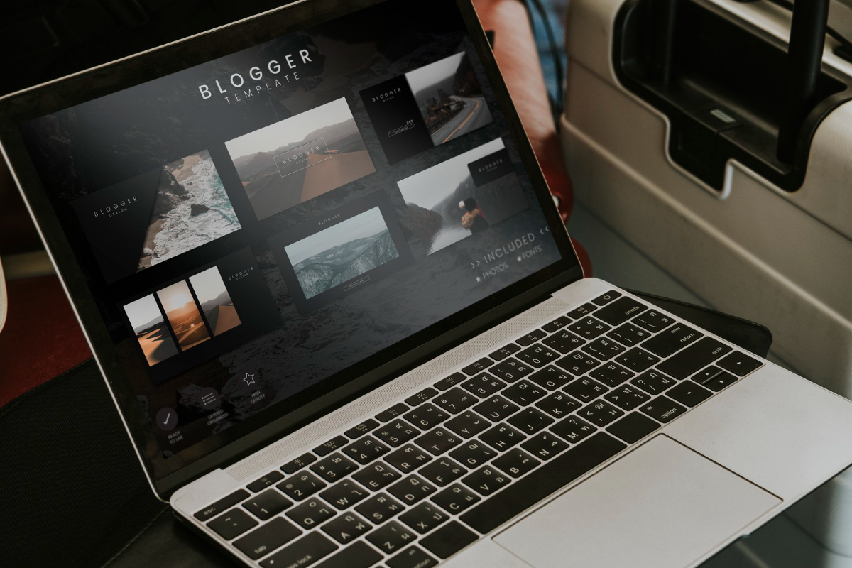 Notebook: design de blog Notebook cinza sobre poltrona ao lado de mala de viagem com mockups de blogs em sua tela