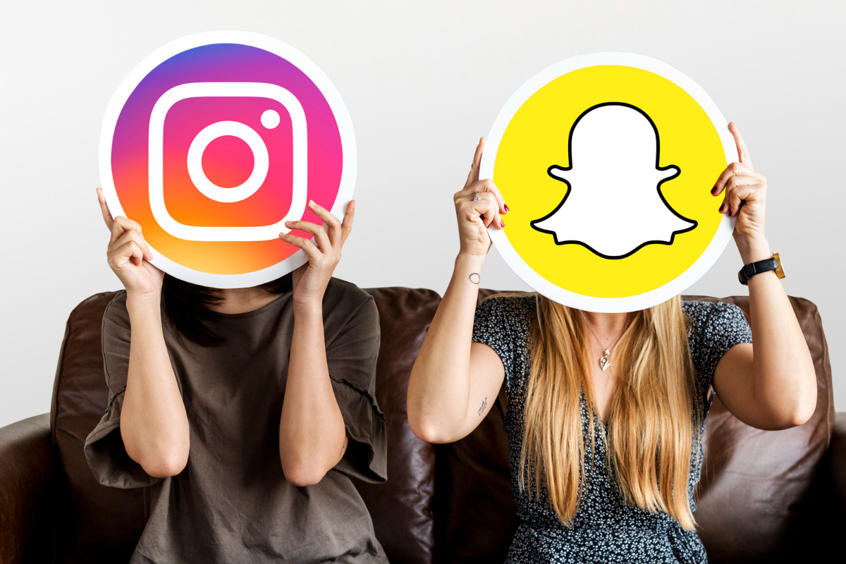 instagram e snapchat: instagram vs snapchat duas mulheres, cada uma com uma placa do instagram e snapchat cobrindo o rosto