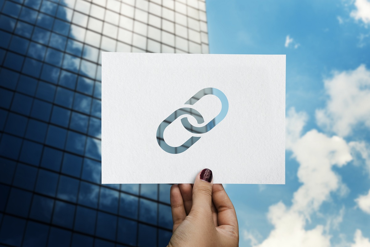 link: tutorial de seo pessoa segurando uma placa com o símbolo de link
