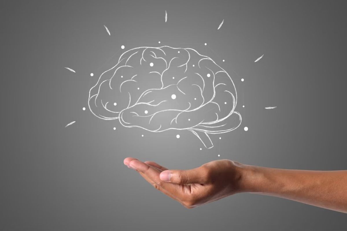 Mente: Mindset Pessoa com mão estendida em forma de cuia mostrando algo no ar que, na montagem em questão, é um desenho de cérebro humano com linhas de expressão representando a mente humana