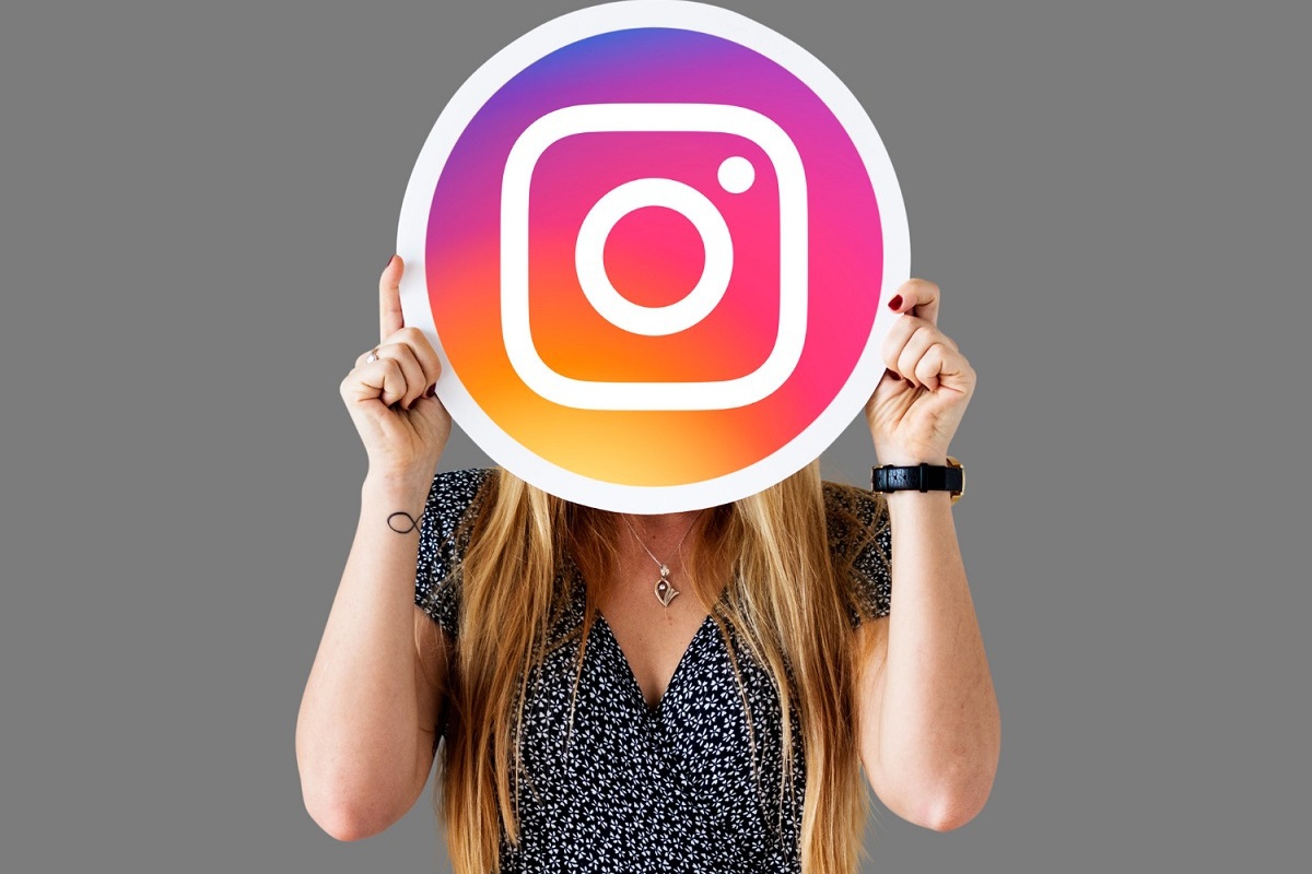 mulher segurando o símbolo do Instagram
