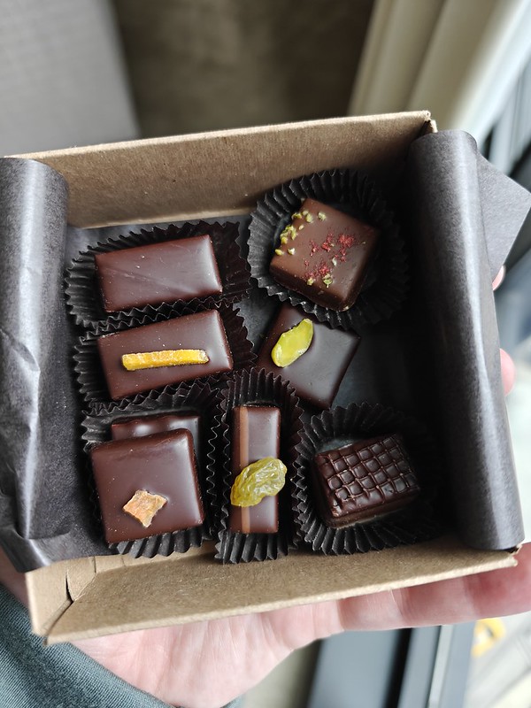 A little square box of chocolates, each one slightly different in appearance and each held in a little dark paper thingy, like a Reese's Cup. 