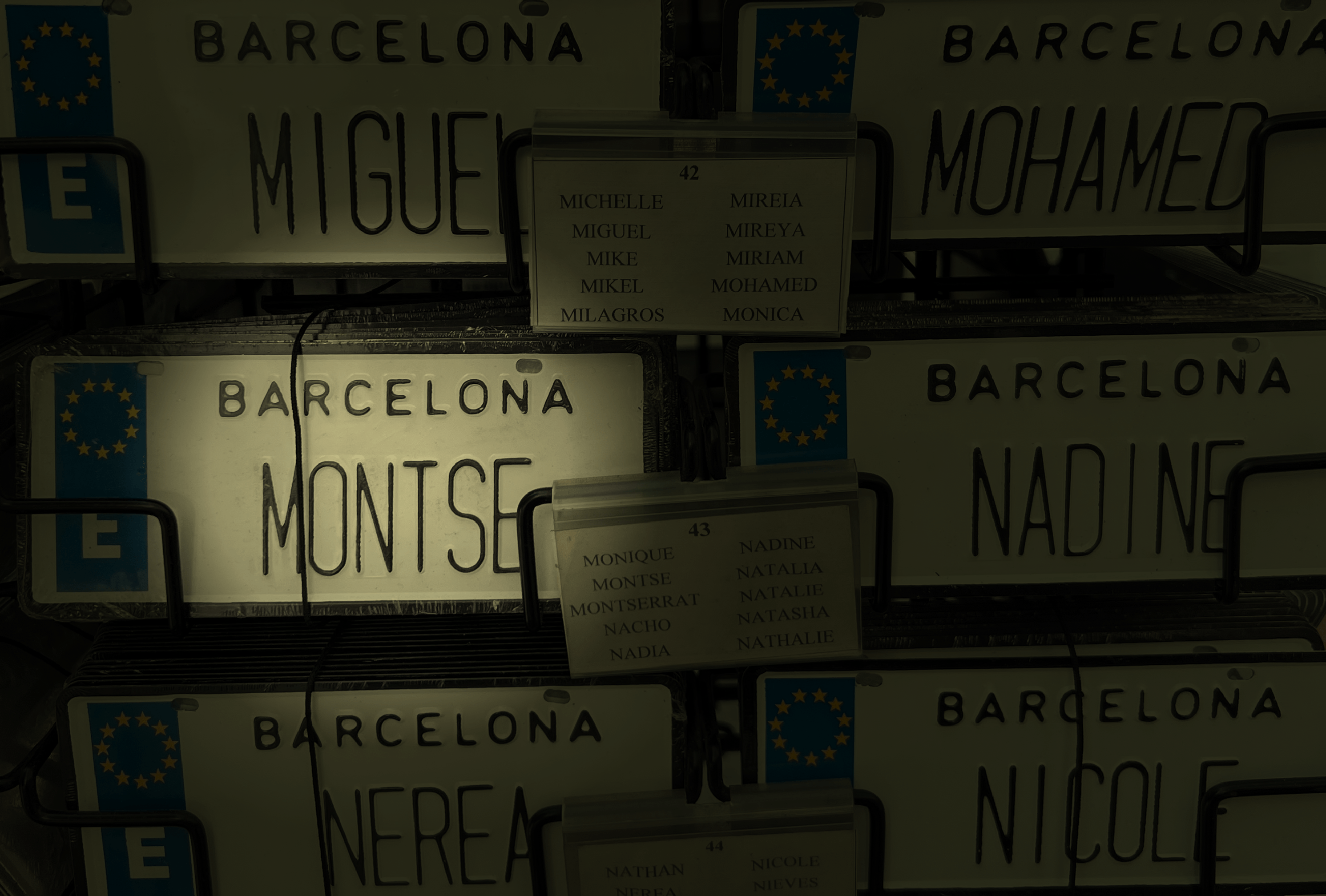 Edited photo of wall collection of Barcelona name plates, with "Montse" highlighted and in focus.