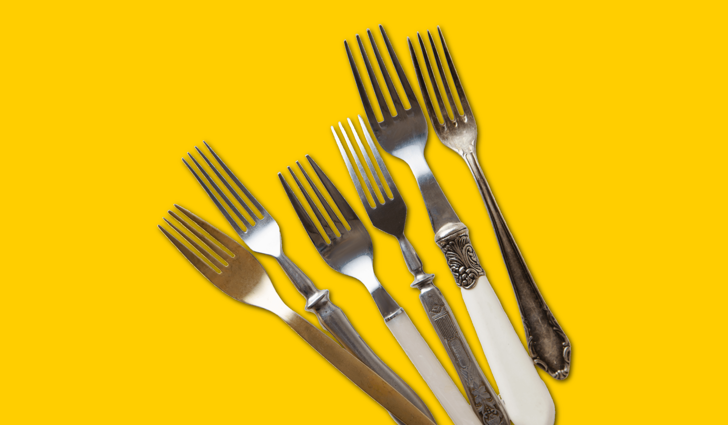 A variety of forks on a yellow background.