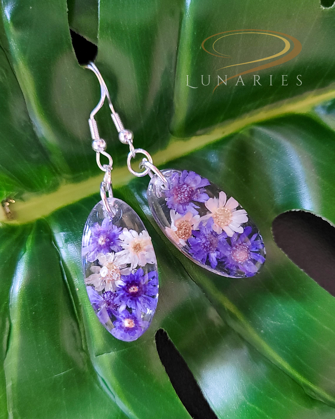 small oval resin earrings with real purple and white flowers