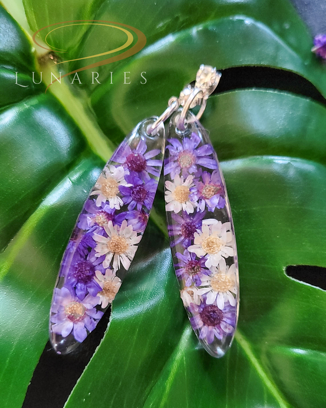 oval resin earrings with real dried purple and white flowers finished with cubic zirconia stud