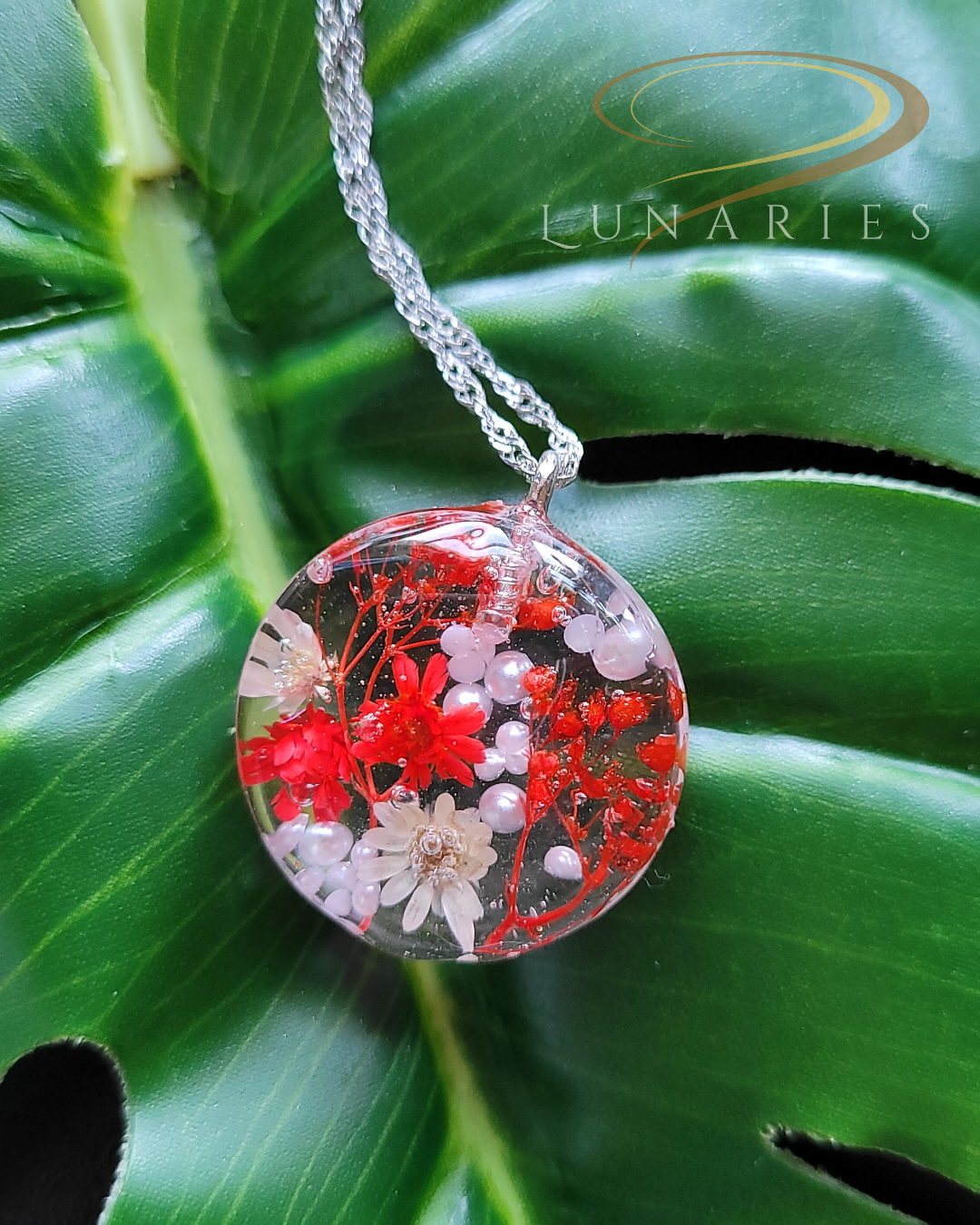 clear round resin pendant with real red dried flowers