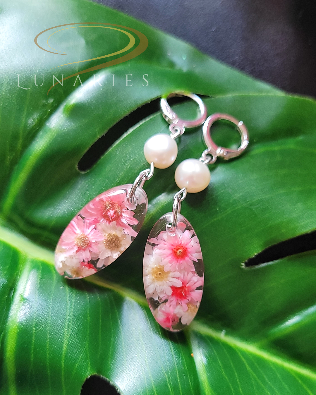 oval resin earrings with pink and white dried flowers faux pearl on a huggie hoop