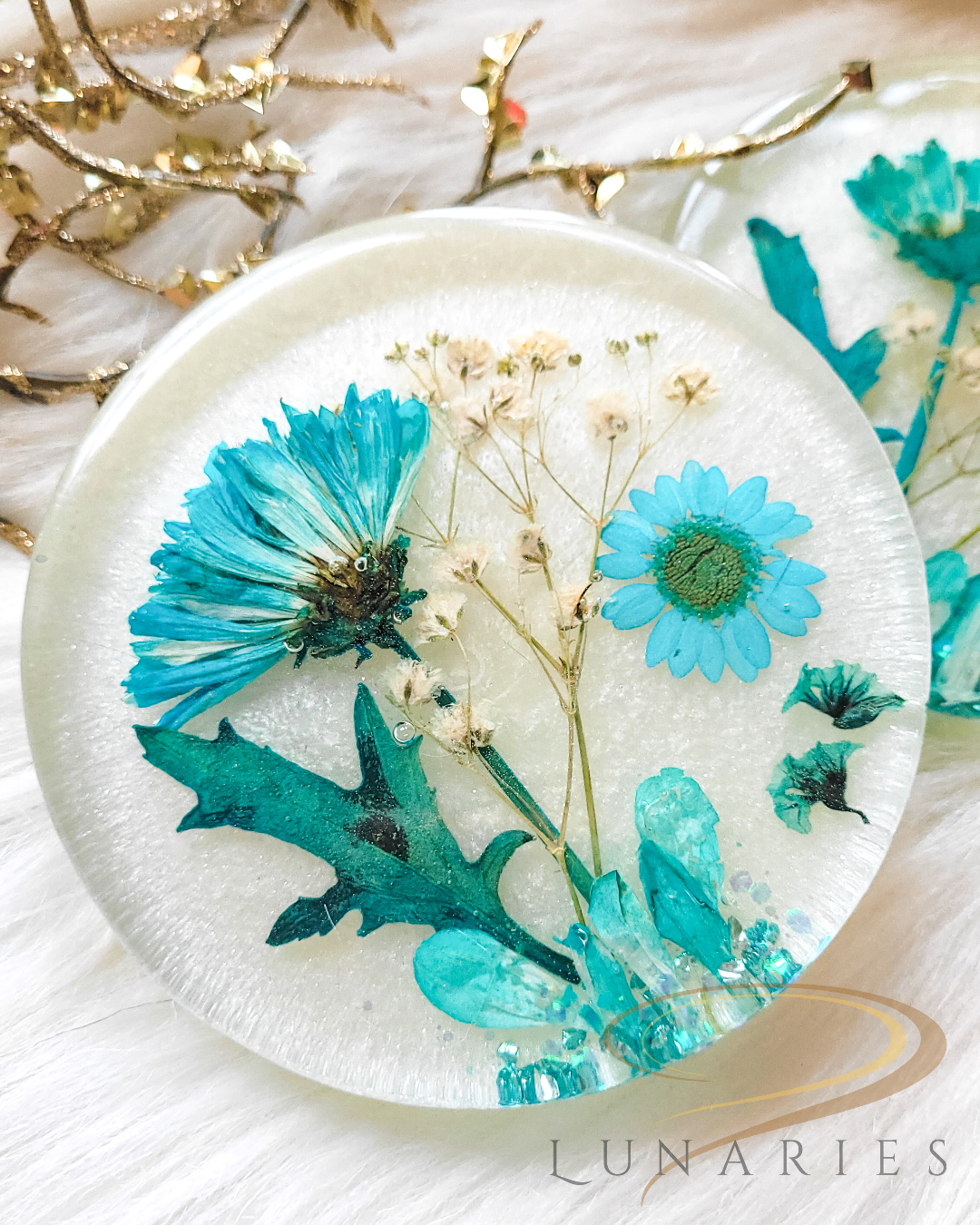 white pearl resin coaster with pressed blue flowers with clear finish