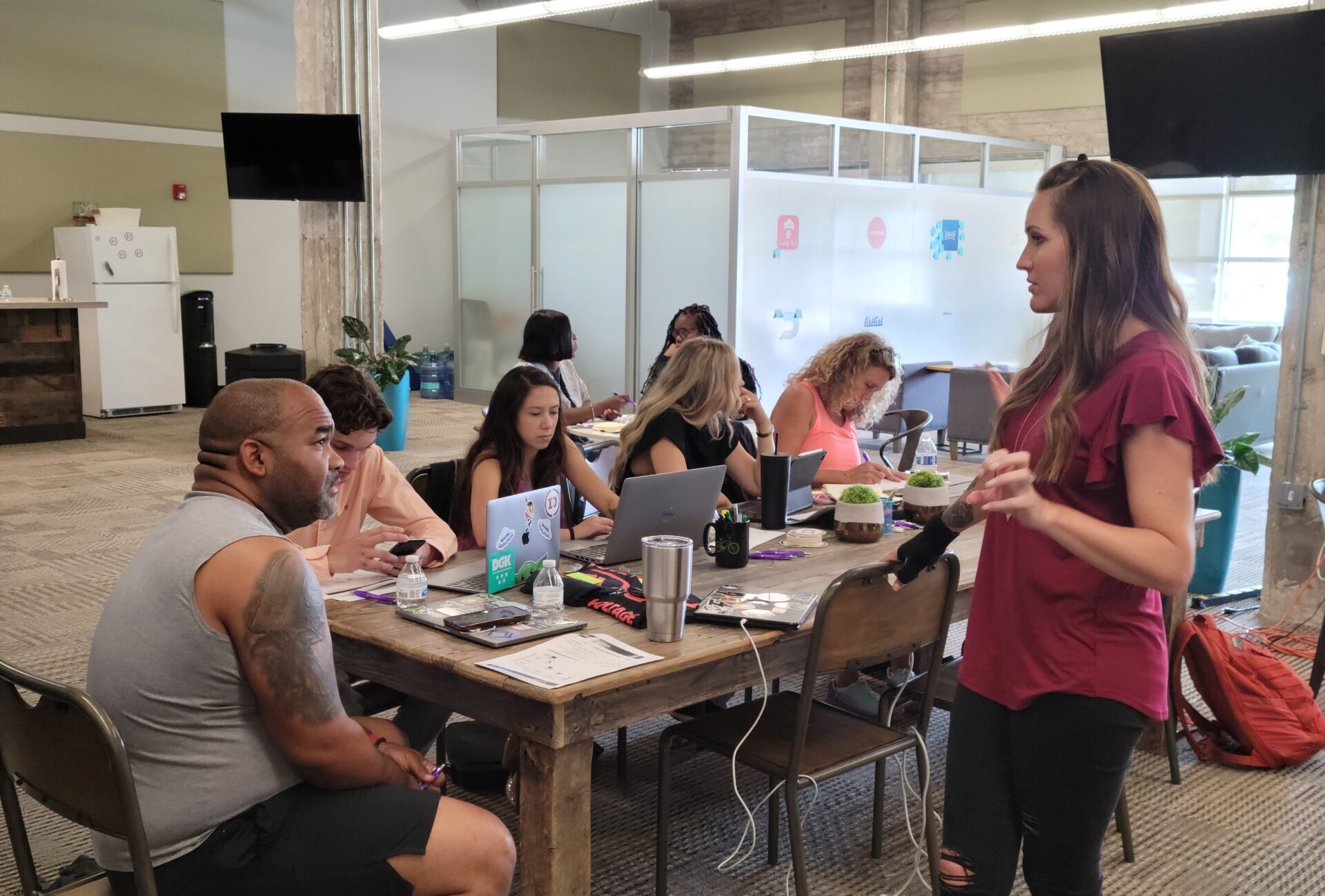 Kelli facilitating a workshop for a group of founders surrounding a conference table