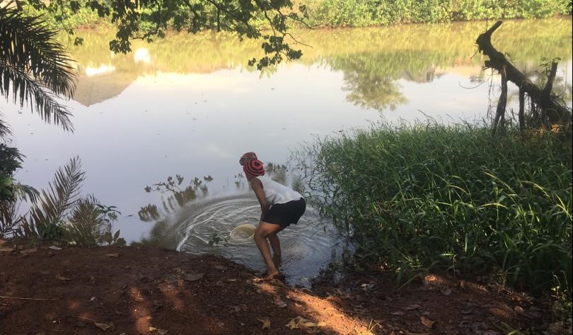 A resident fetching water from Mmiri Ihe Ọjọọ. Photo source: Chiamaka Ozurumba