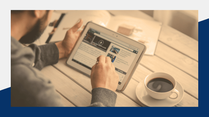 Person reading news on a tablet.