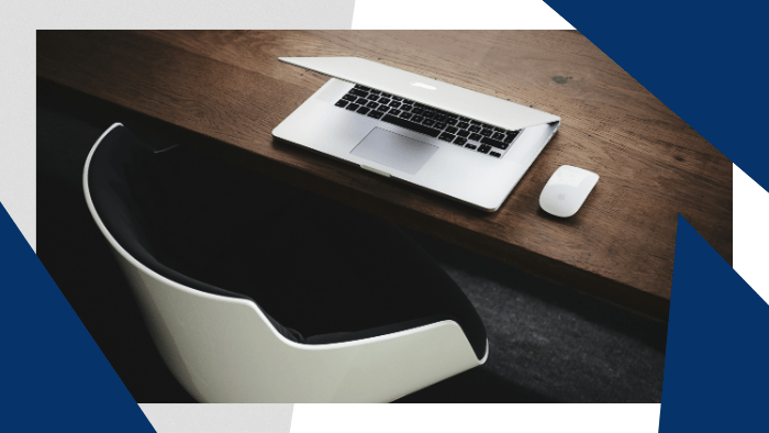 Laptop and mouse on top of a desk