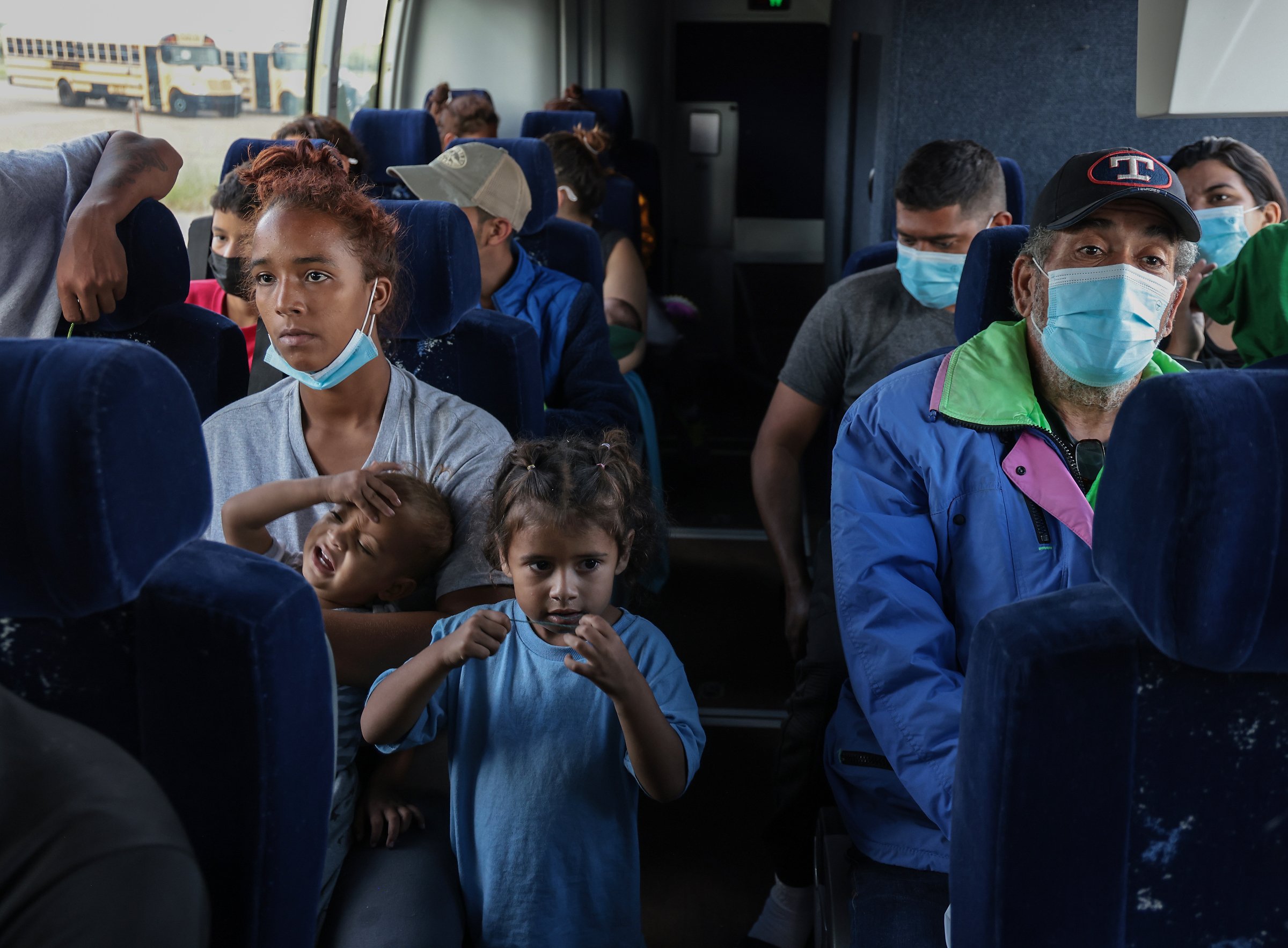Asylum-seekers travel by bus along the Texas-Mexico border.