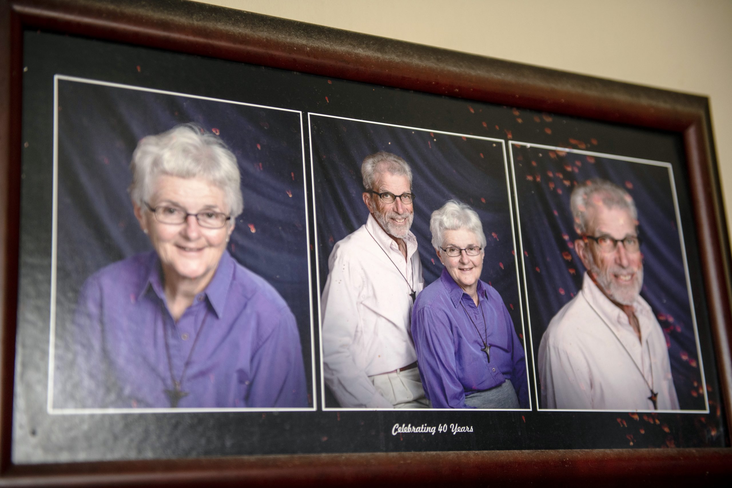 Framed photos of a white man and woman