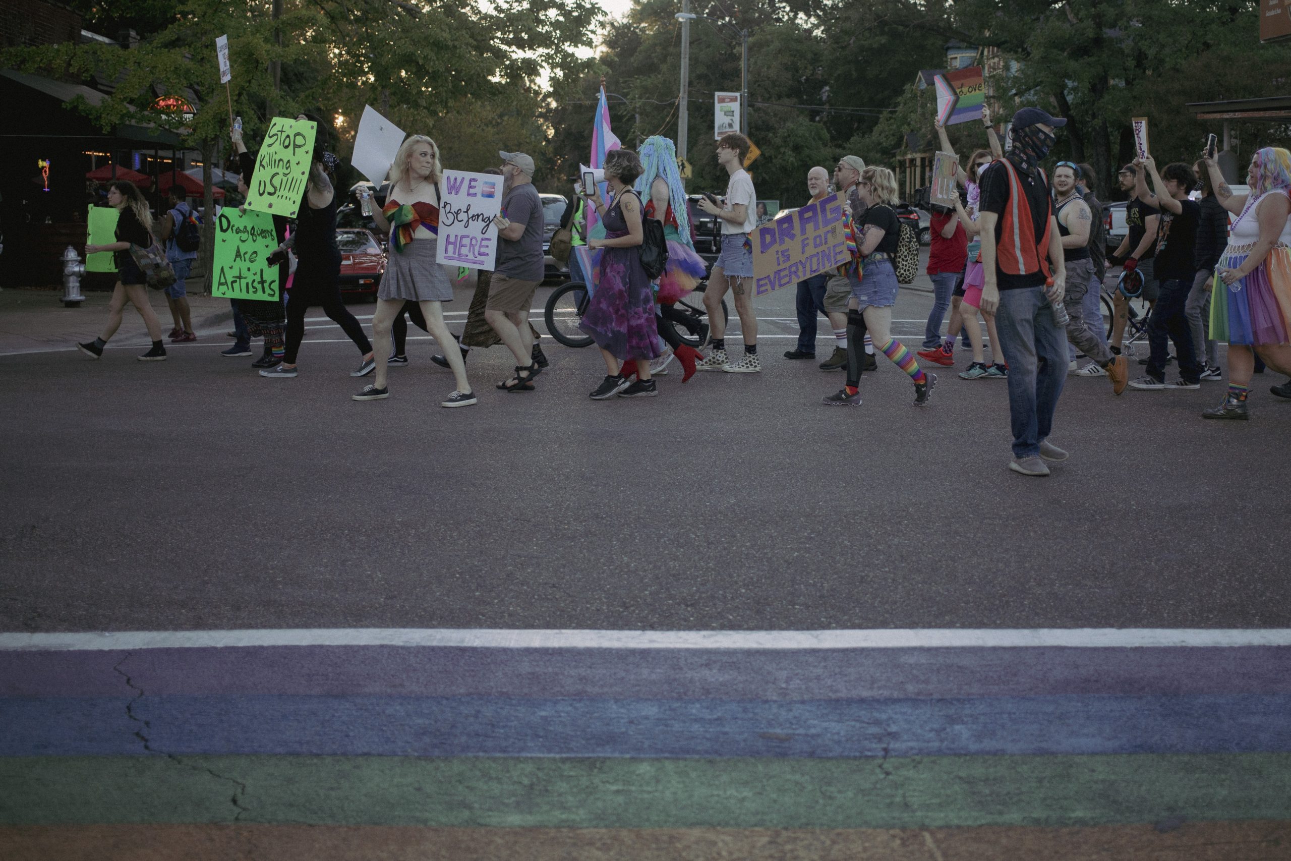 A group of people march along a street.