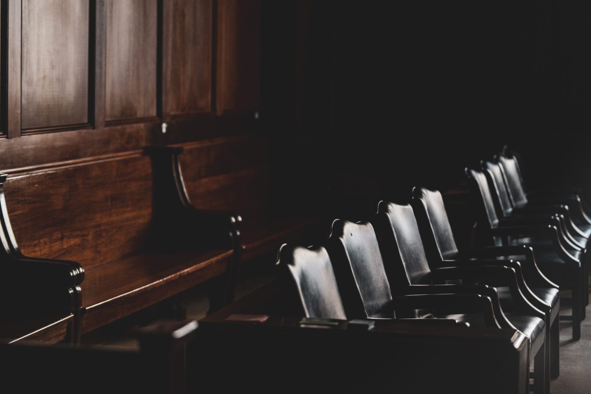 Light shines on a row of courtroom seats