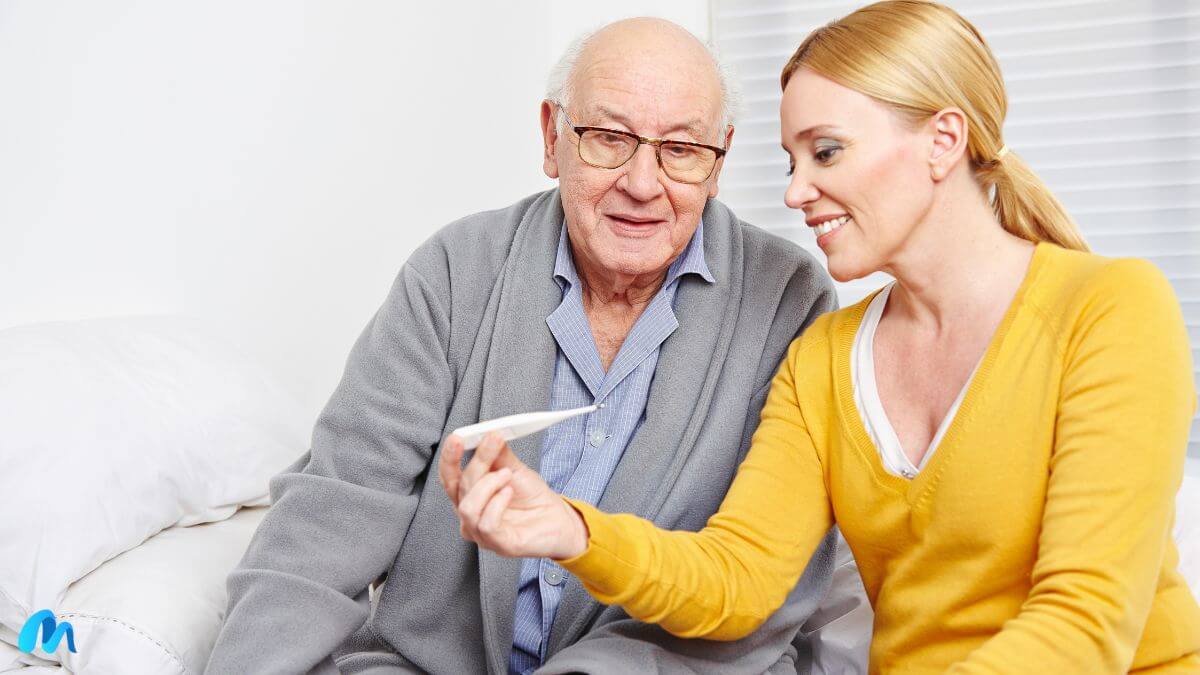 Senior man in grey suit looking at thermometer with a nurse-ashwagandha for alzheimer's