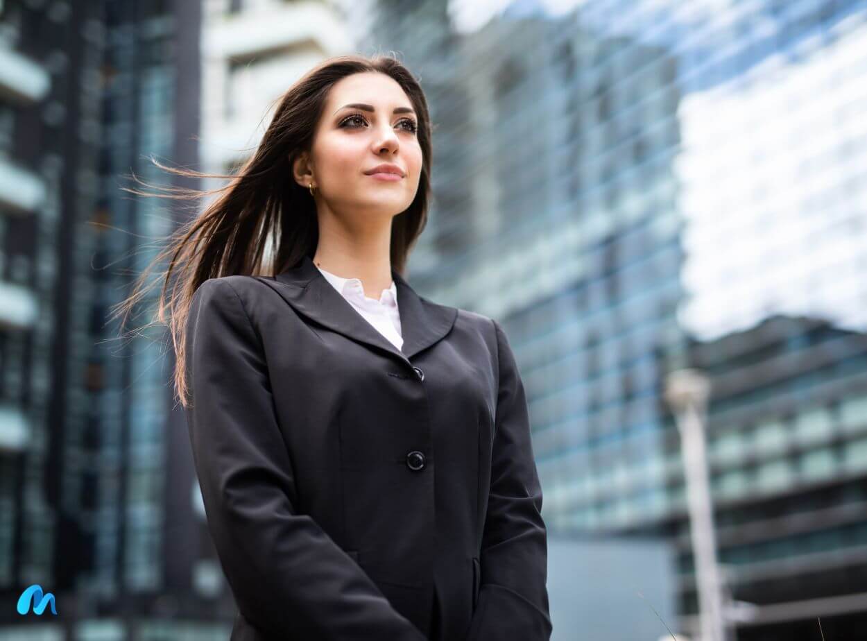 Business woman in black suit standing in front of high rise buildingstips for achieving great success