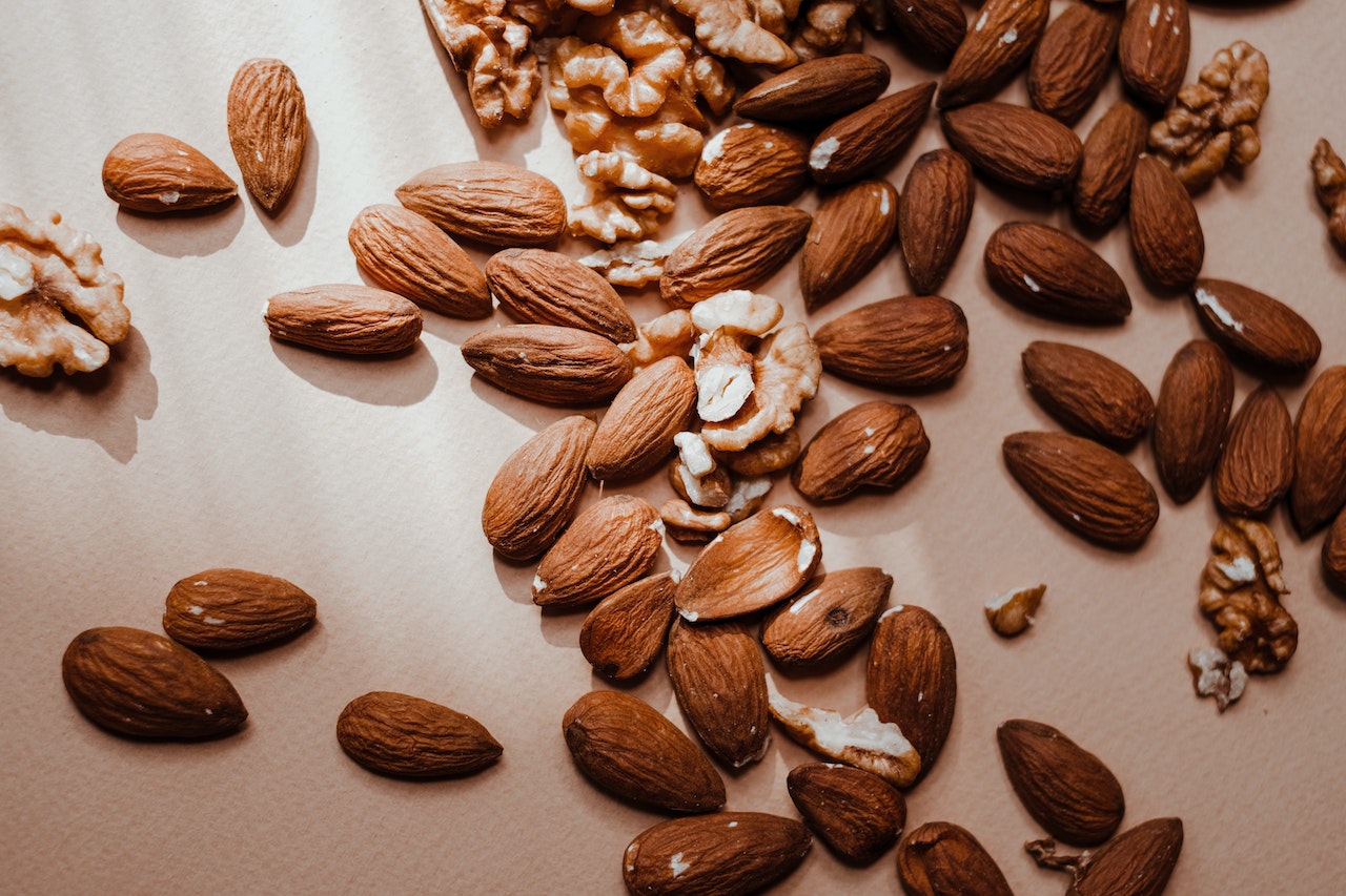 A brown almonds and walnuts on a flat surface-almonds glycemic index