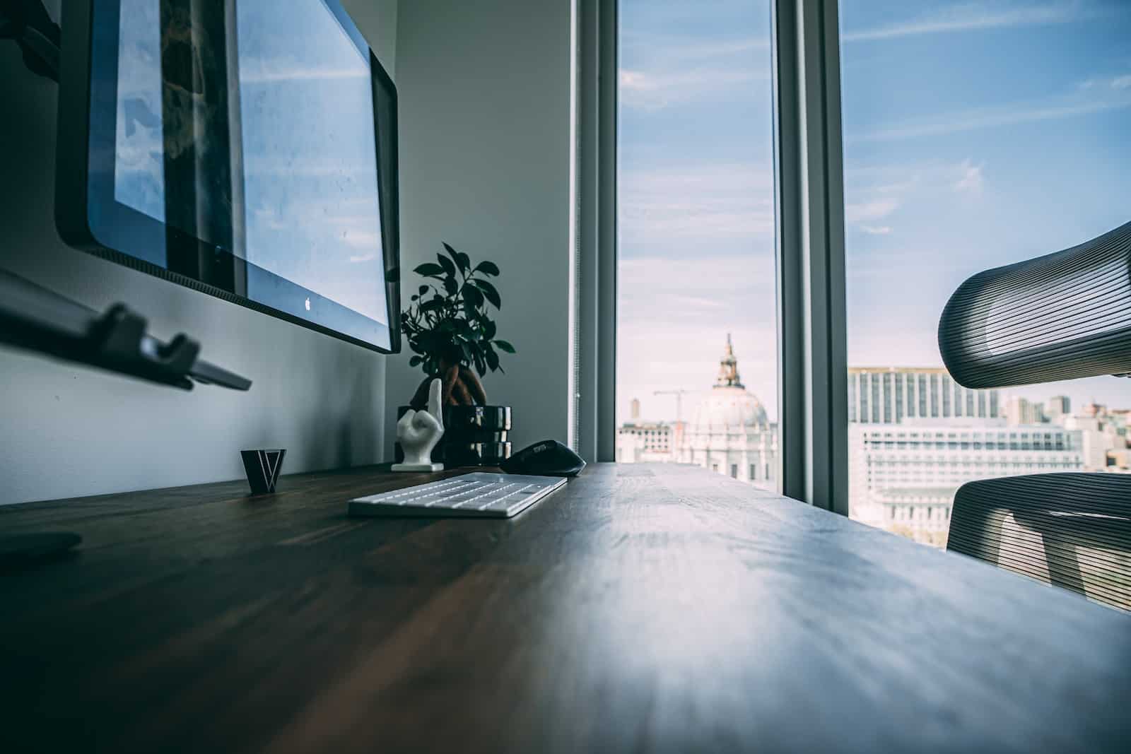 Black laptop computer on brown wooden table-art of single tasking