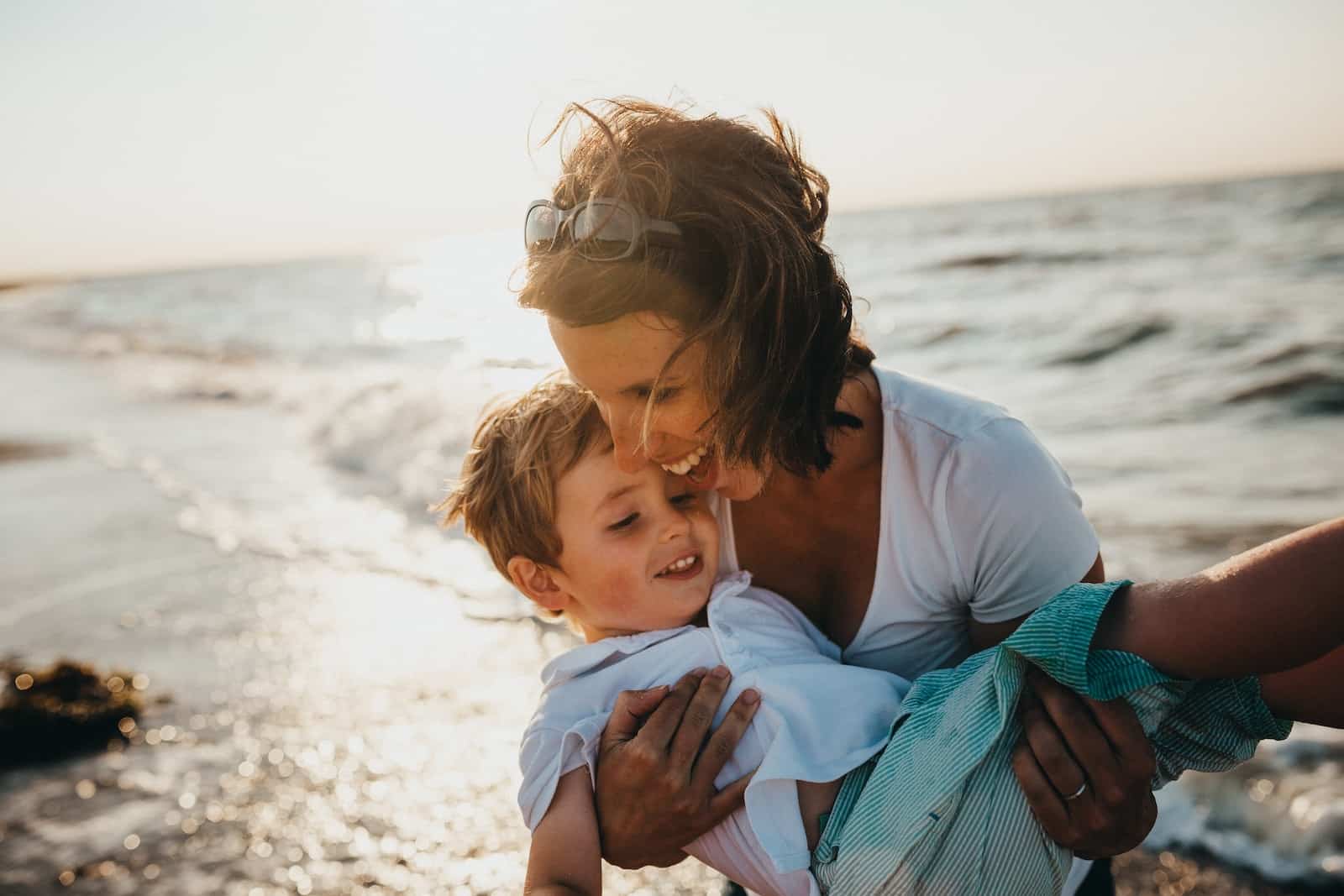 Photo of mother and child beside body of water-breaking free from busynes