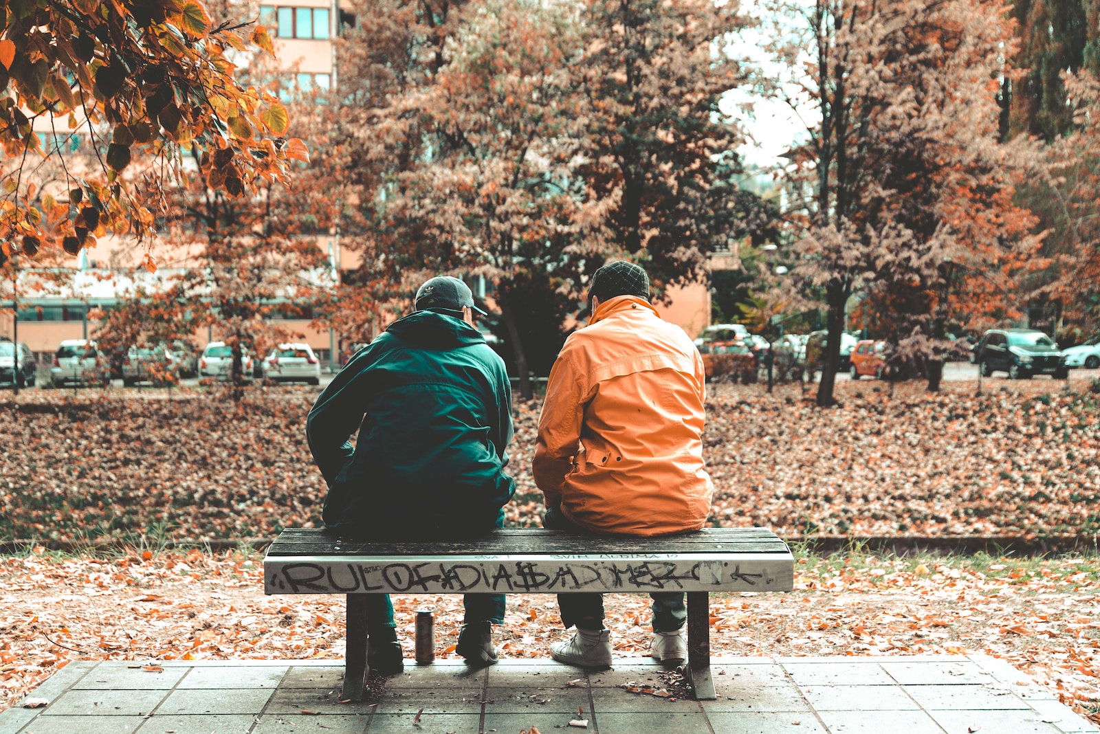 Two men sitting on bench-check in on your friends