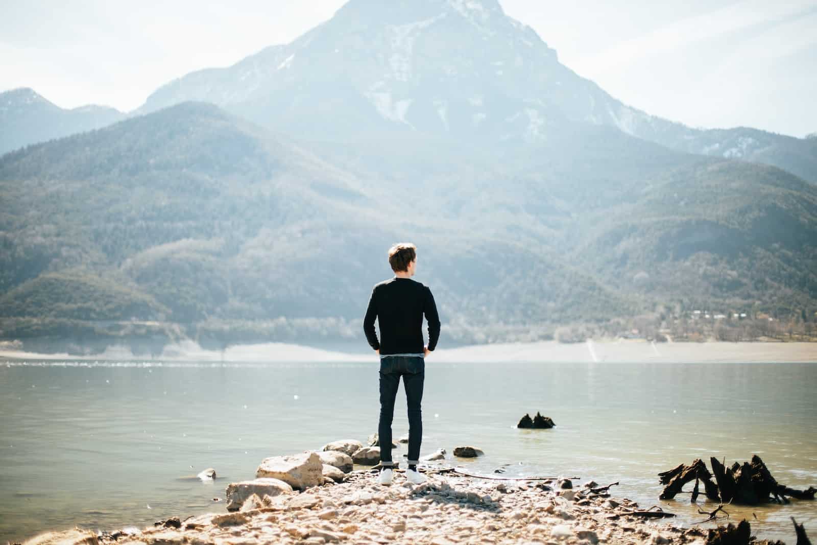 Man standing on front of lake at daytime-emotional well being
