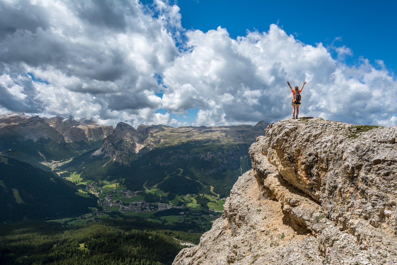 Woman standing on mountain-goals as focus
