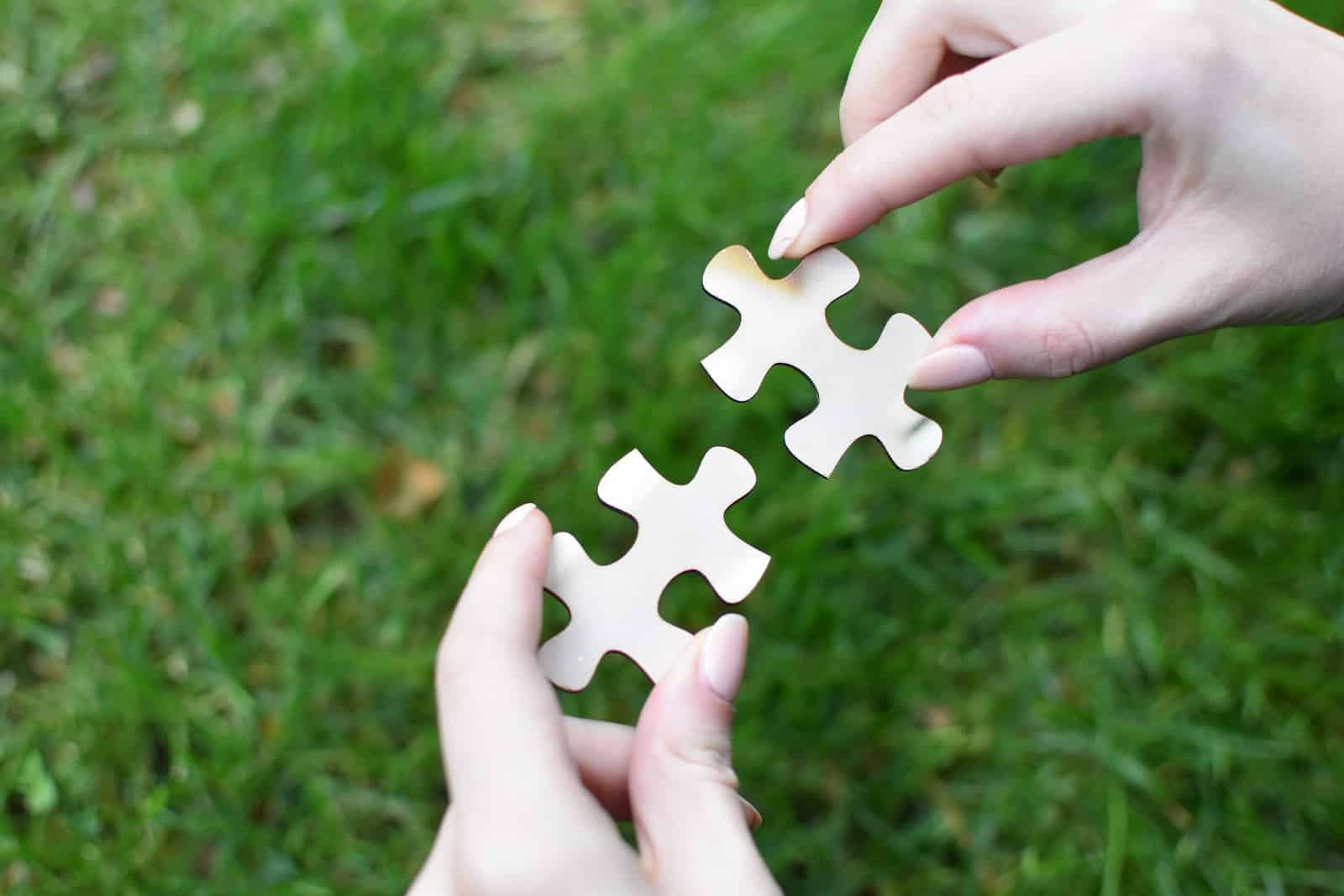 A person holding a piece of a puzzle in their hands-how to connect with anyone