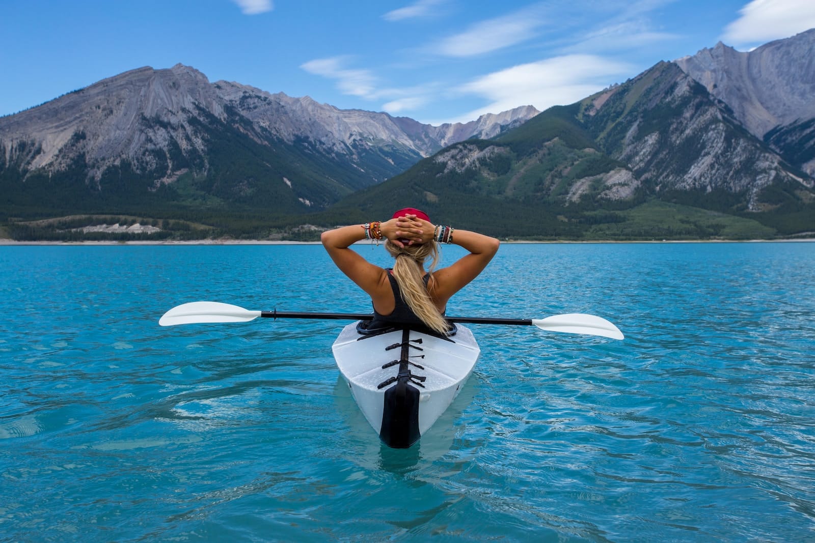 Woman riding kayak at the middle of the sea-living freely