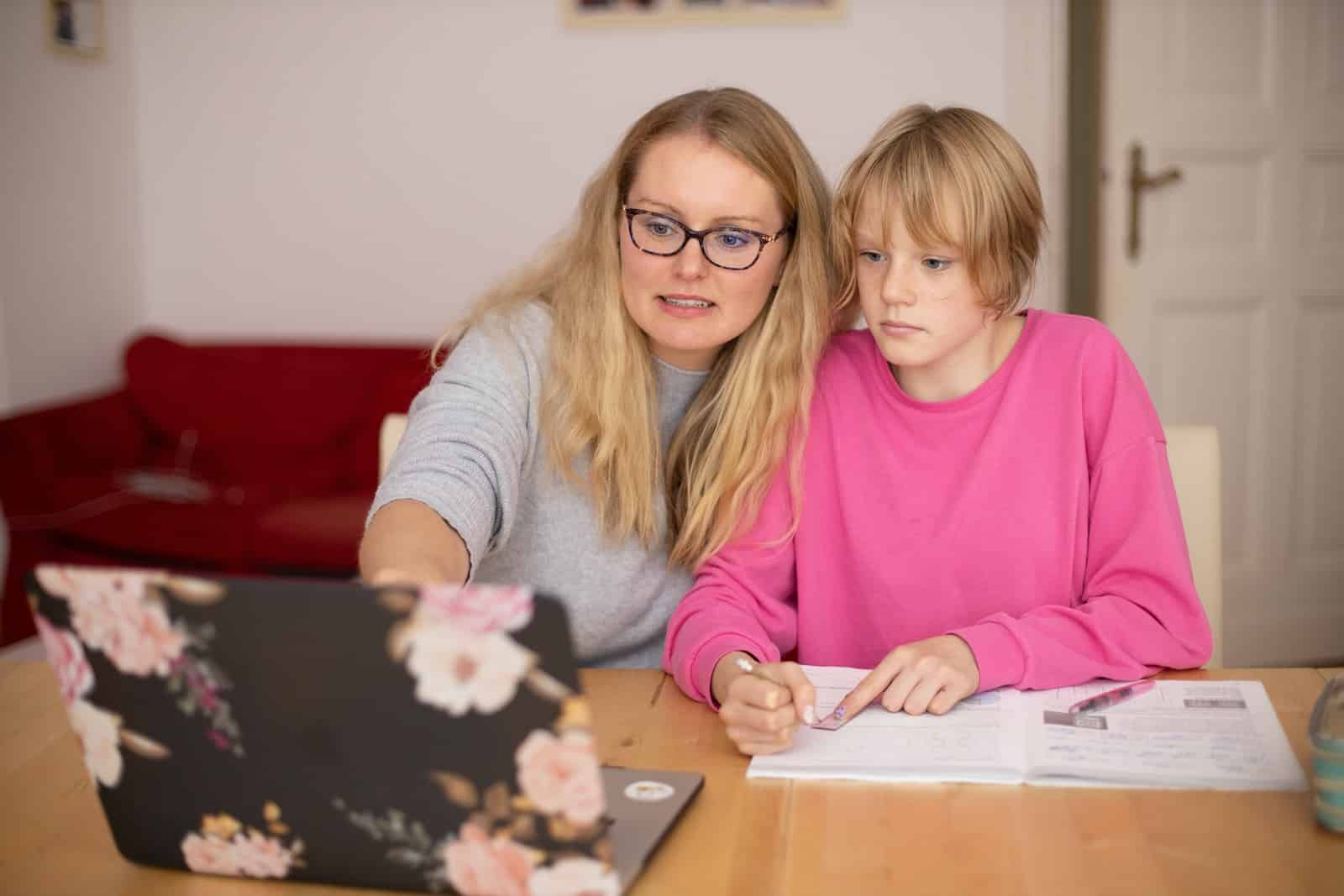 Girl in pink sweater beside girl in gray sweater-potential of homeschooling