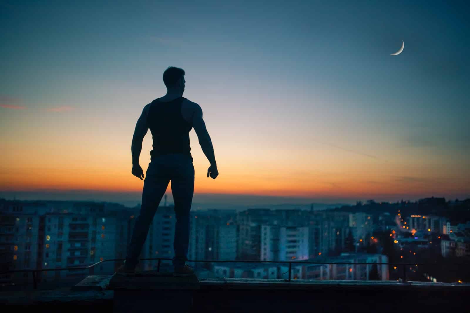 Silhouette photography standing on peak front of high-rise buildings-staying motivated