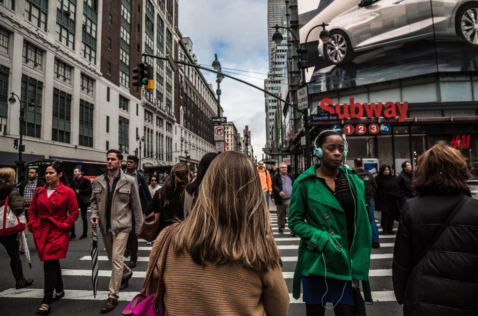 Woman wearing green jacket walking on the pedestrian lane during daytime-people make time for what they want