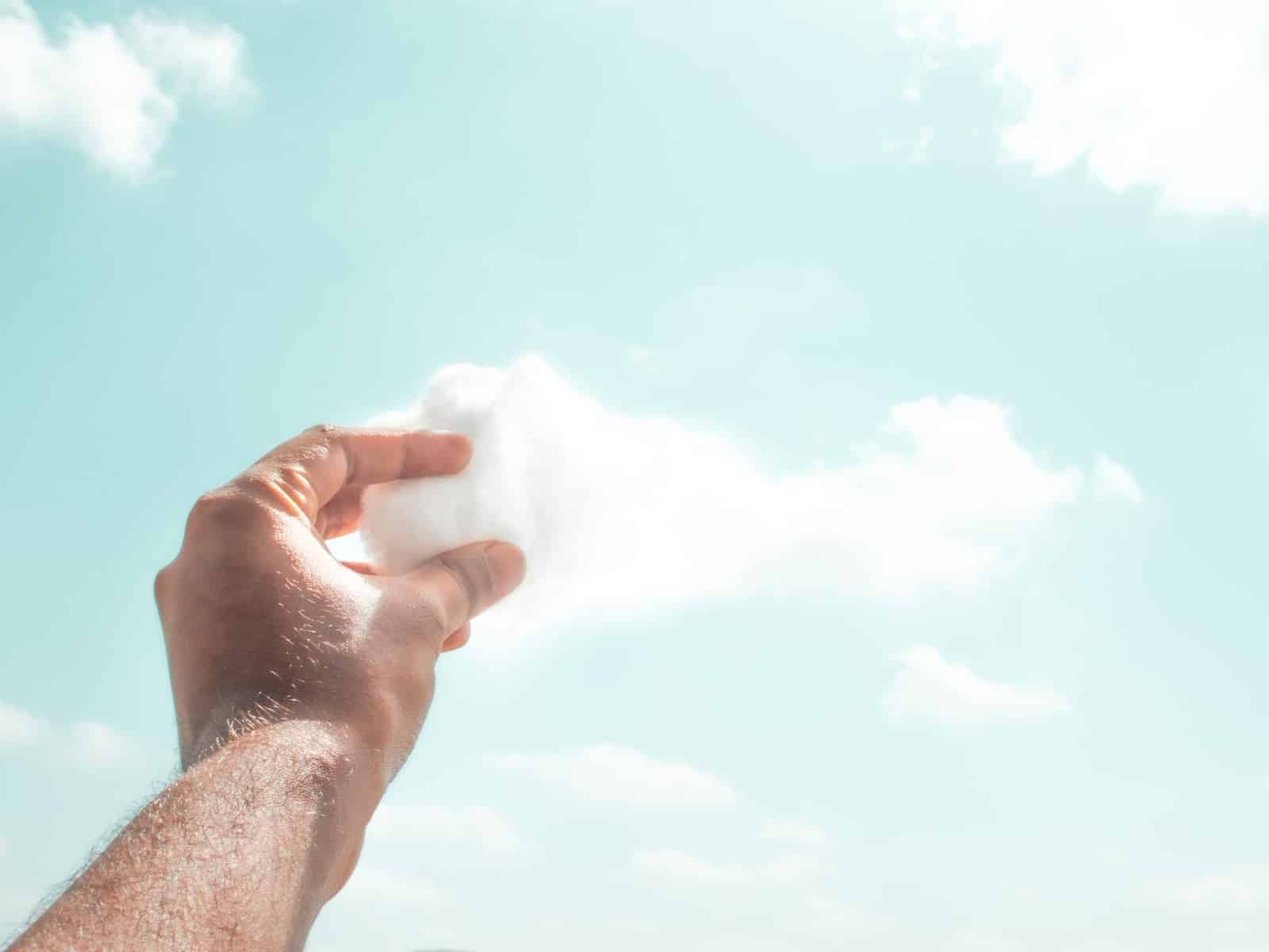 Person holding white cotton candy
