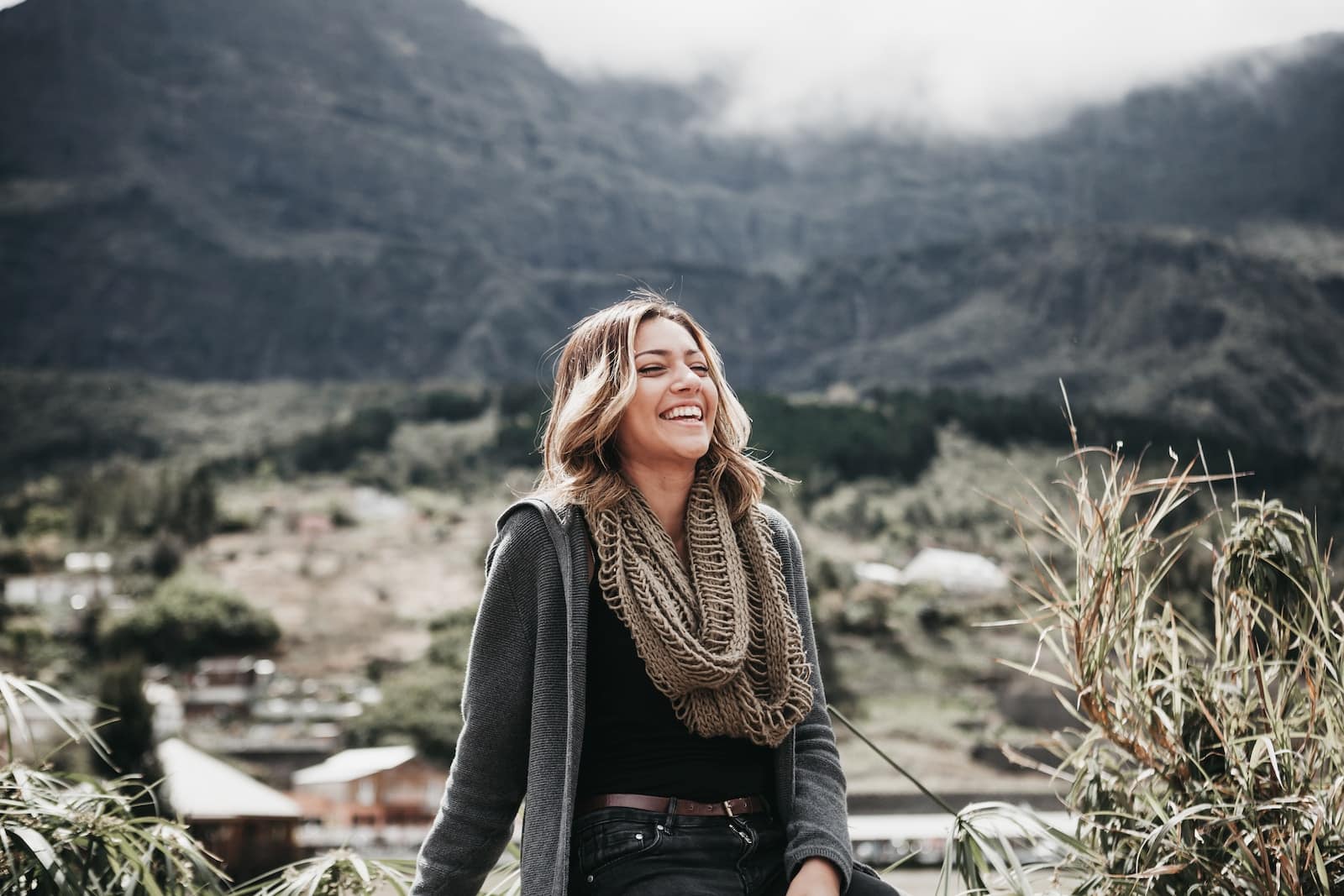 Woman sitting beside grass near mountain range-introvert and extrovert both