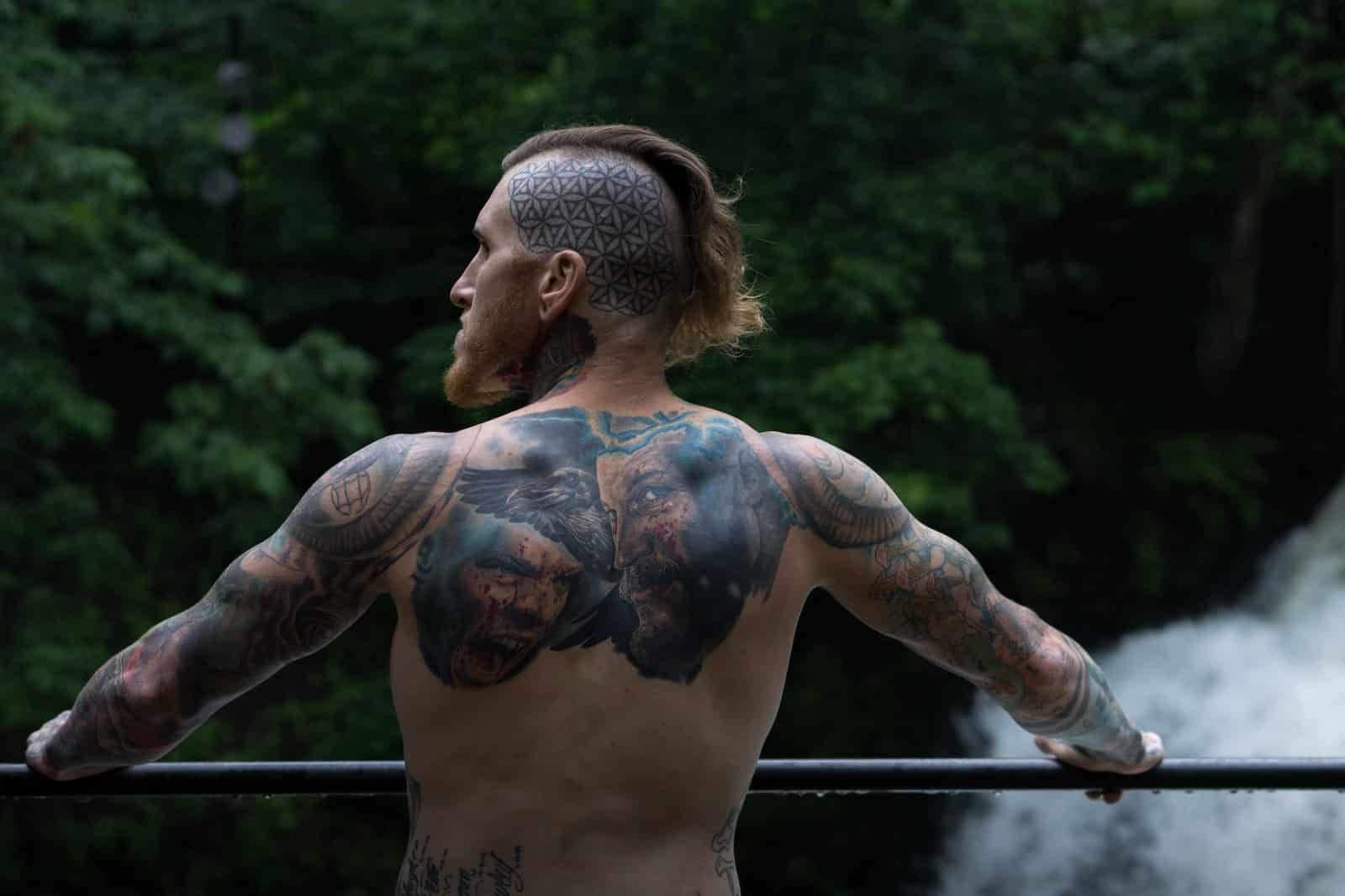 Selective focus photography of topless holding on black rail during daytime-can you build muscle without protein