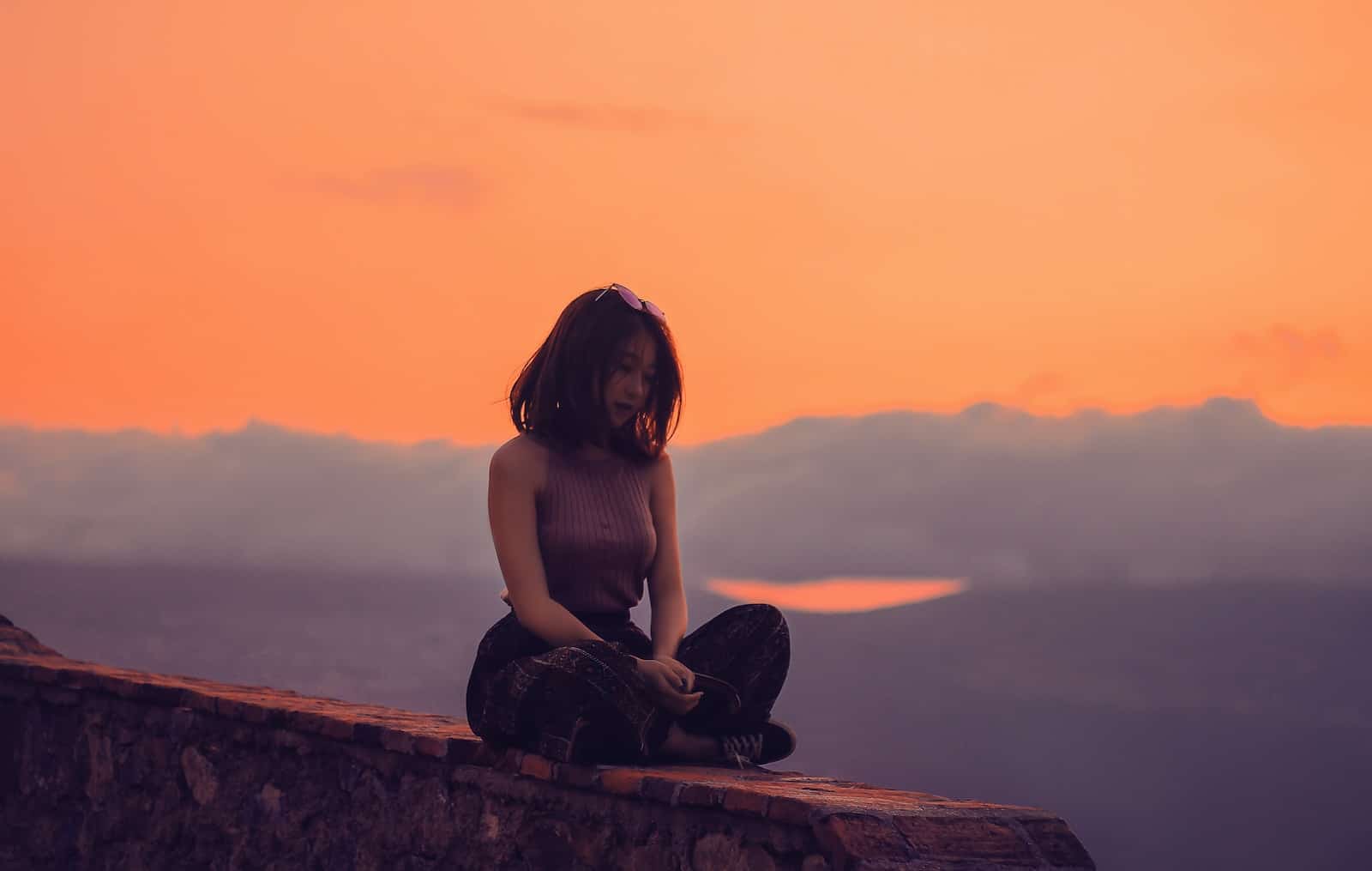 Woman sitting on a cliff-why do i get burned out