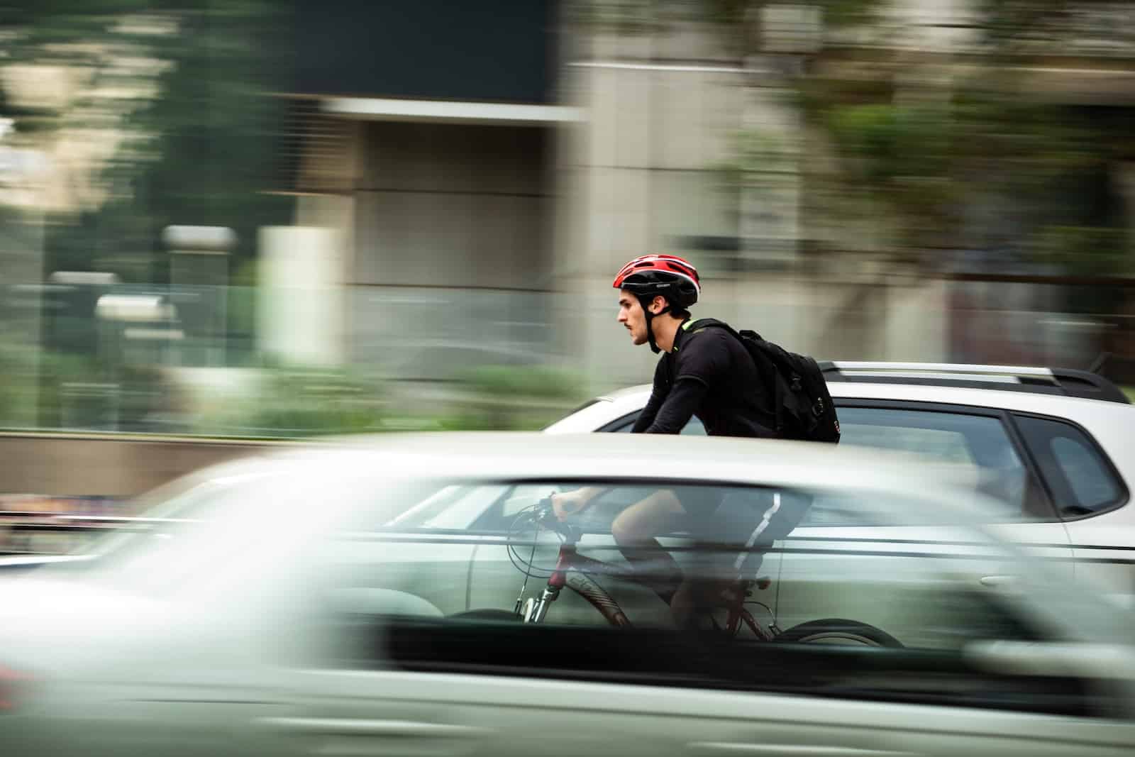 Man riding bicycle near car-i shirk my duty means