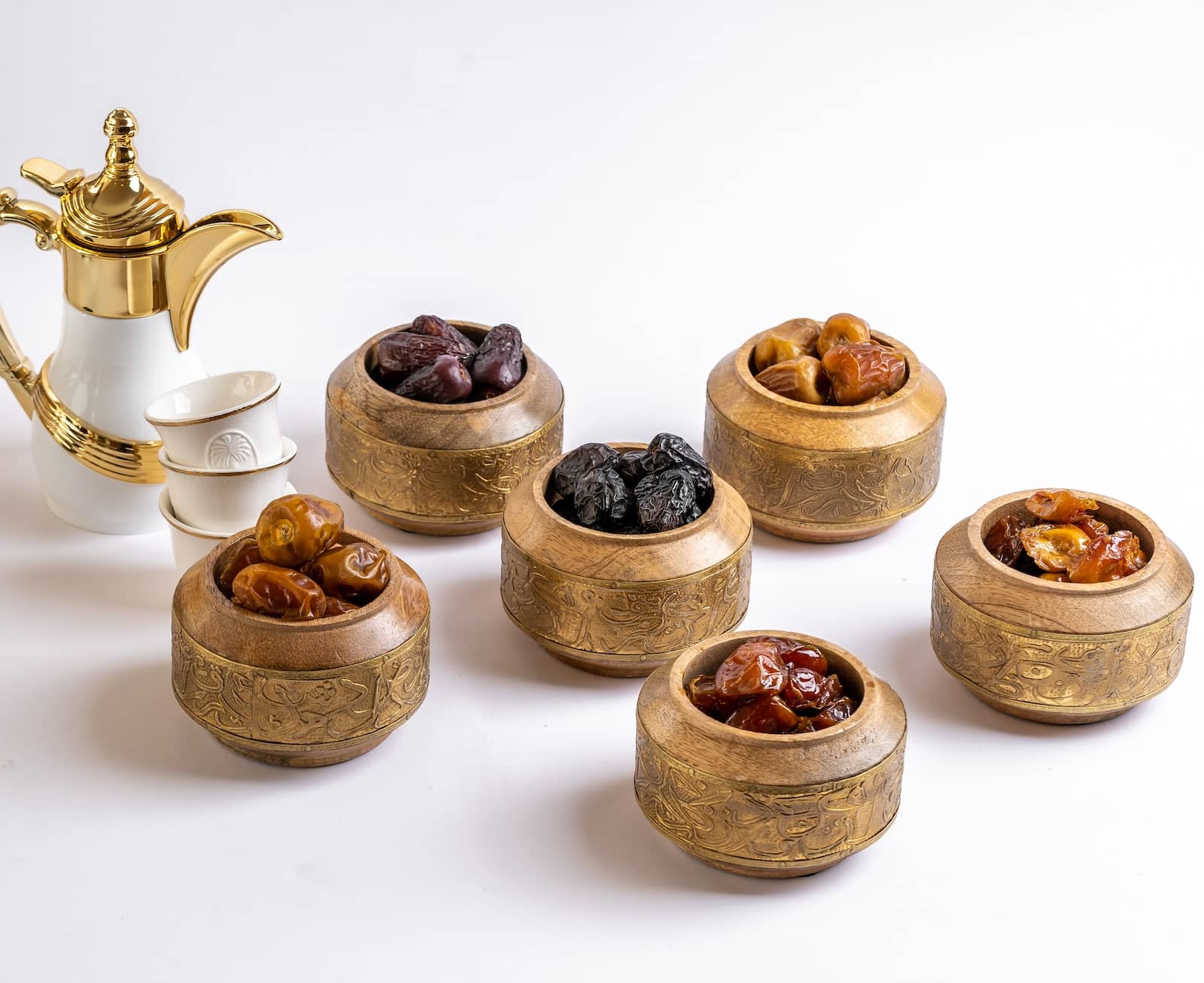 A group of small wooden bowls with brown objects in them-do dates have protein