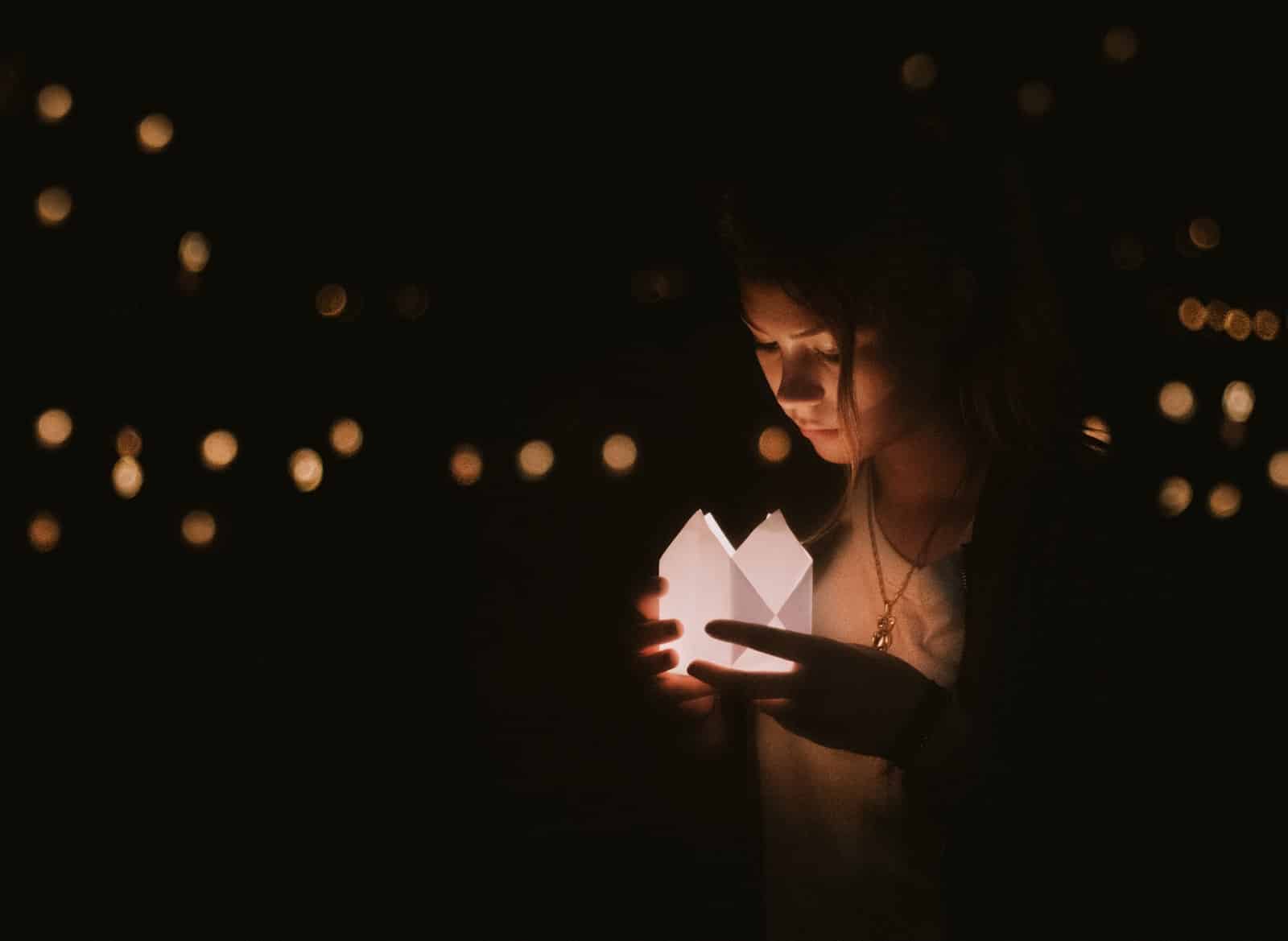 Bokeh photography of woman holding paper lantern-dealing with emotional baggage
