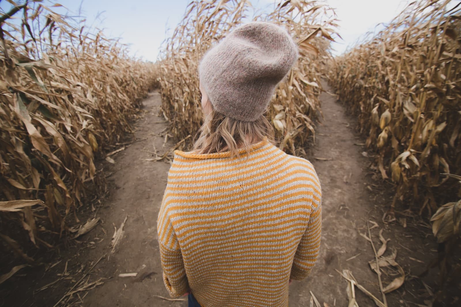 Woman standing in brown field while looking sideways-decision fatigue