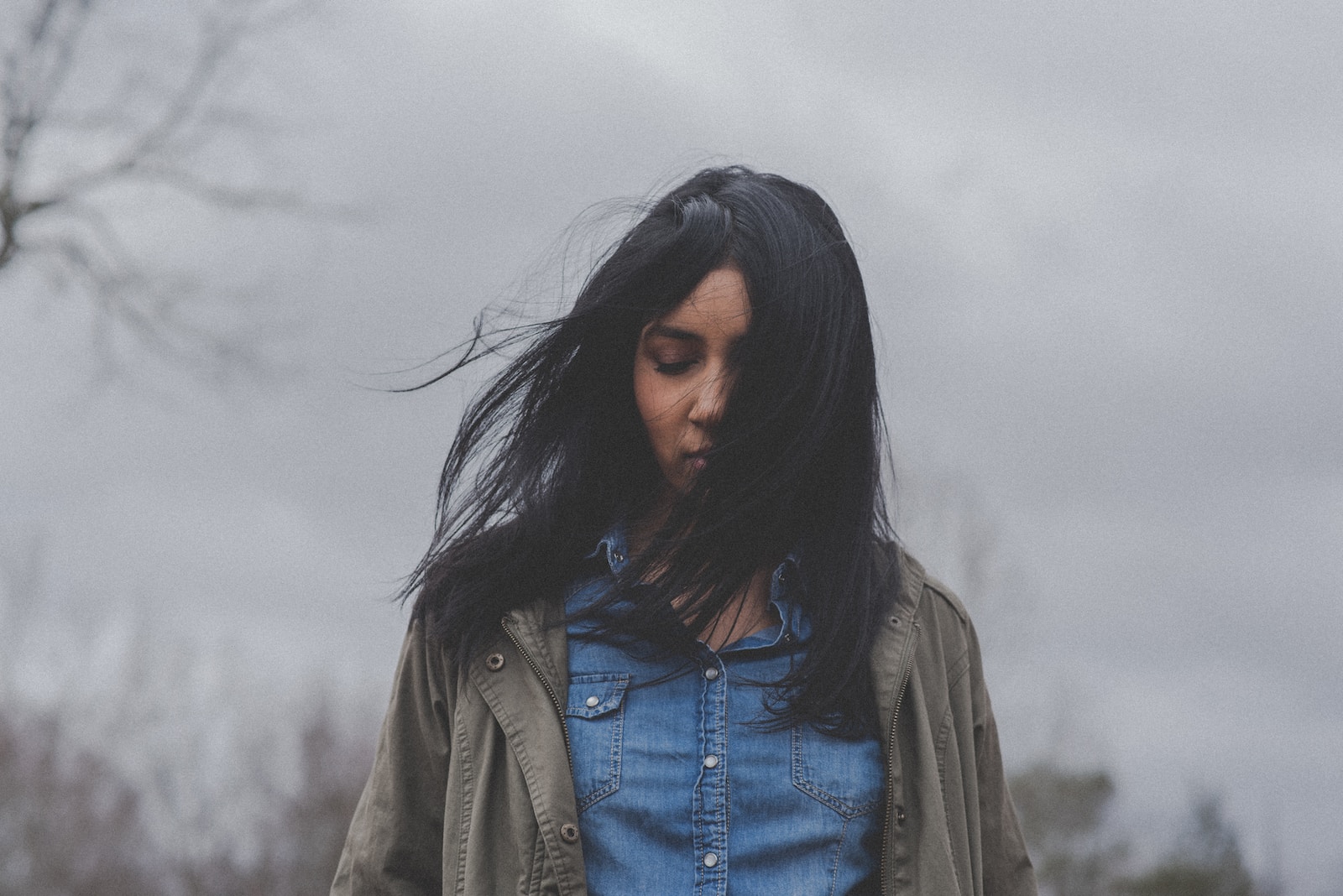 Woman in denim button-up shirt-emotional baggage vs emotional trauma