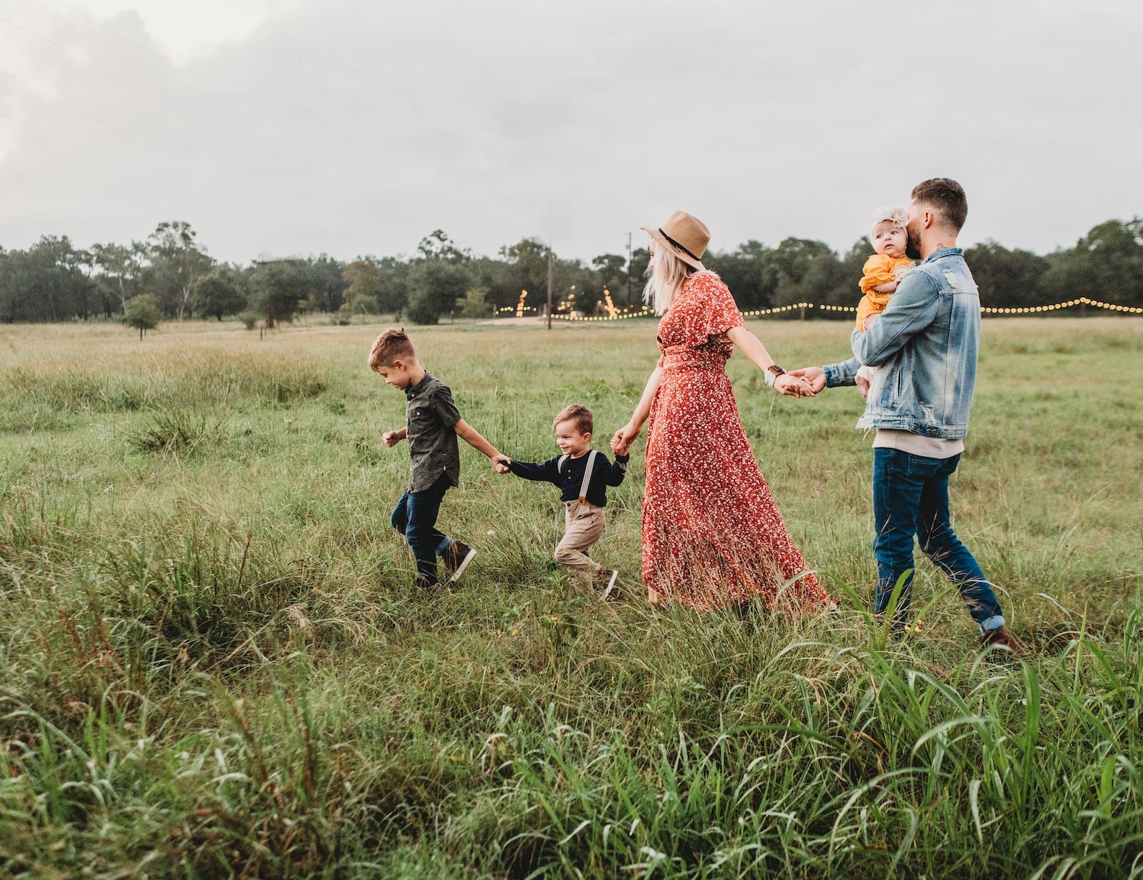 Woman holding man and toddler hands during daytime-achieve family goals