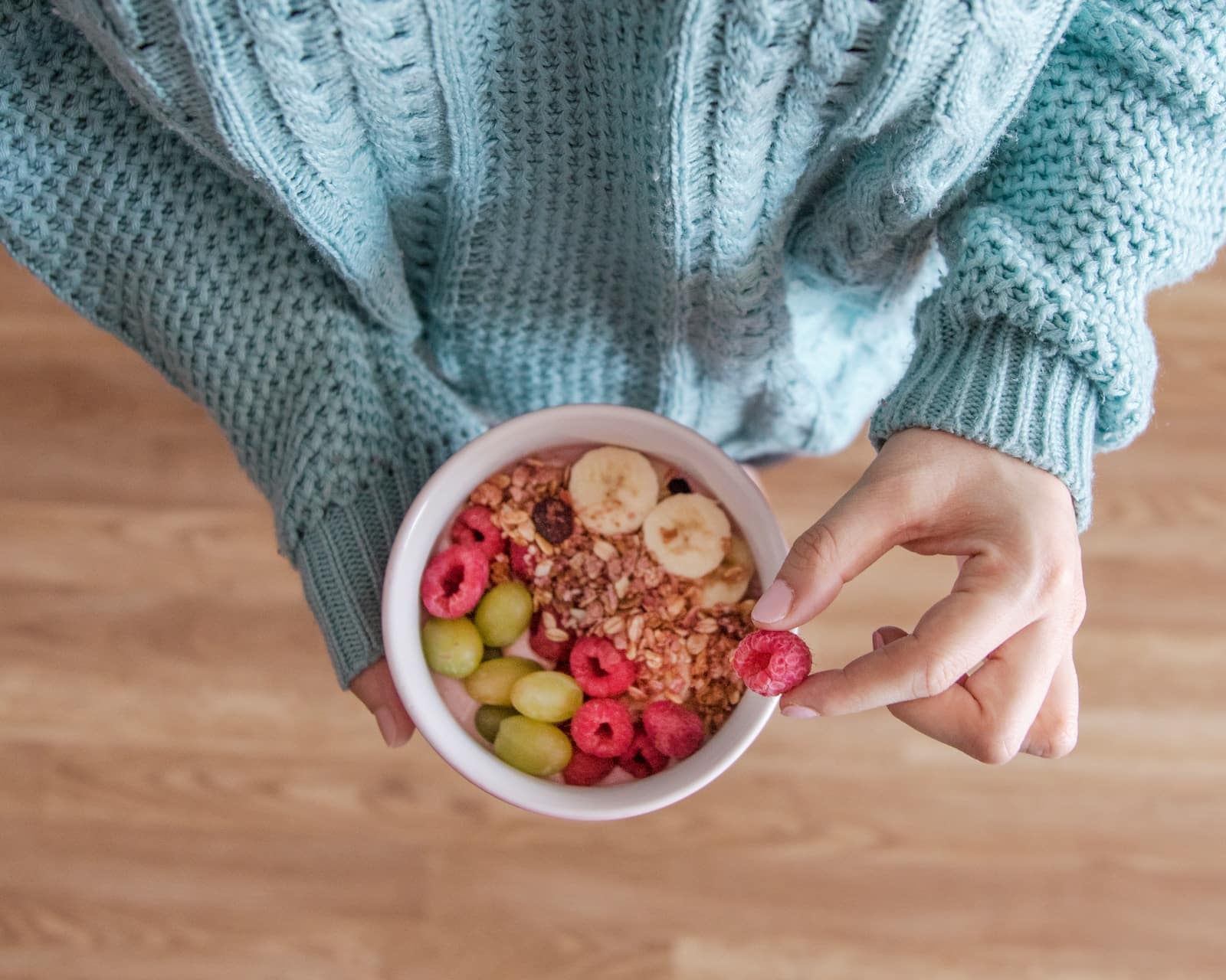 Person holding white ceramic bowl with red and yellow beans-can oatmeal cause constipation