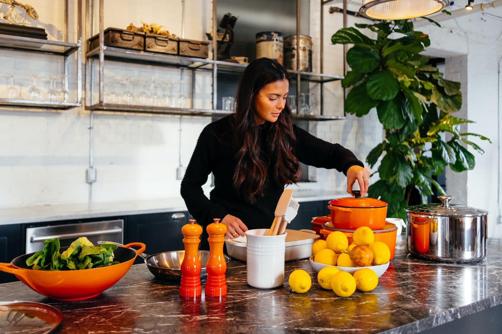 Woman standing in front of fruits holding pot's lid-what happens to your body when you start eating organic