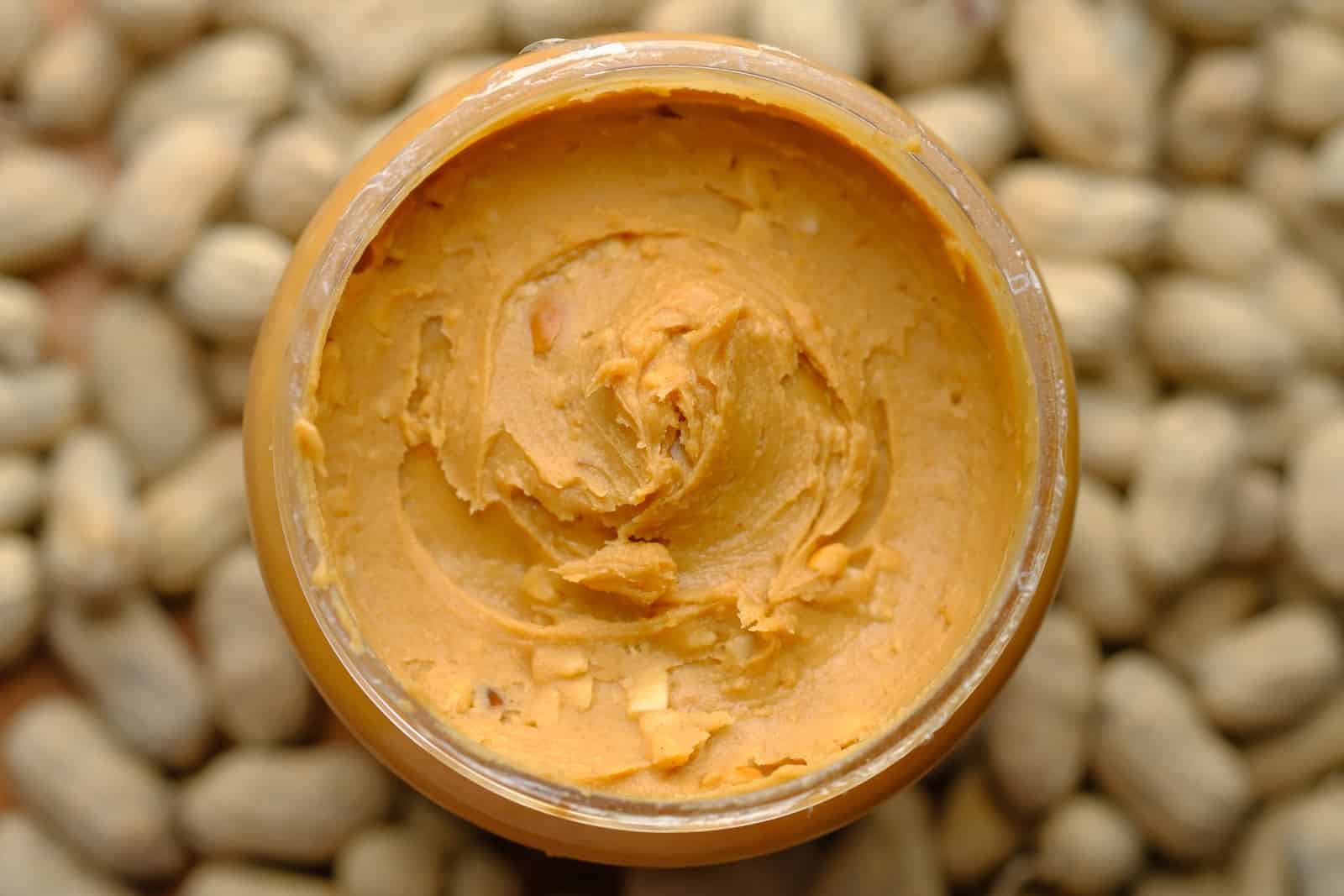 Brown powder in brown round container-peanut butter benefits for skin