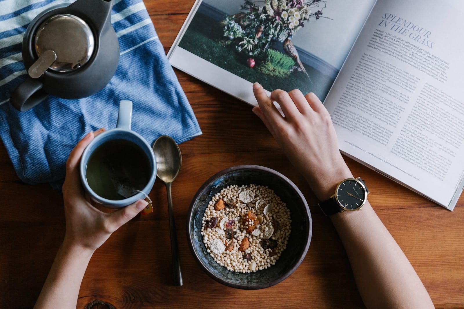 Person holding blue ceramic mug and white magazine-quinoa and pregnancy